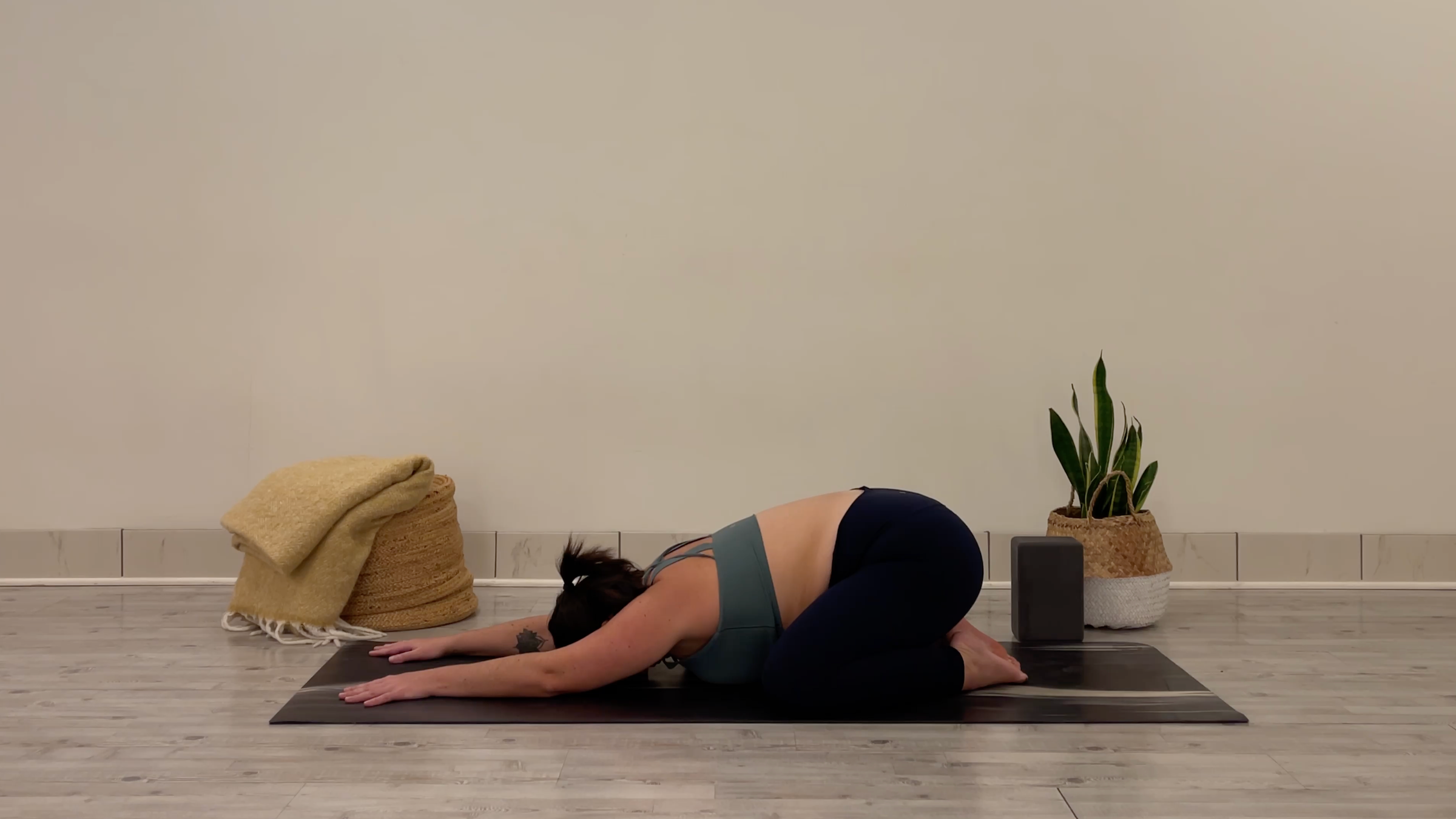 Yoga teacher Taylor Lorenz in Child's Pose, part of her yoga practice to beat the winter blues