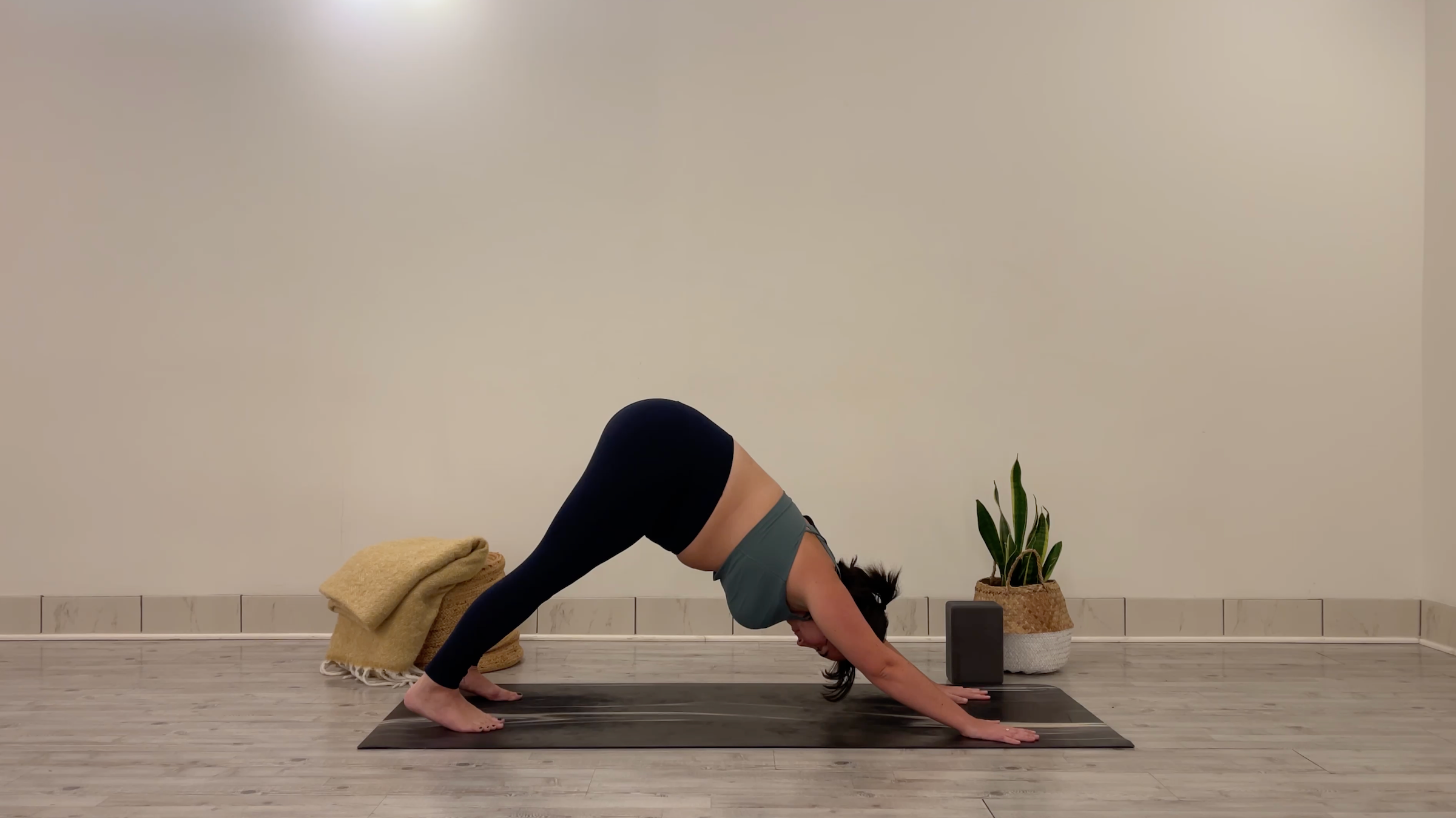 Yoga teacher Taylor Lorenz in Downward-Facing Dog, part of her yoga practice to beat the winter blues