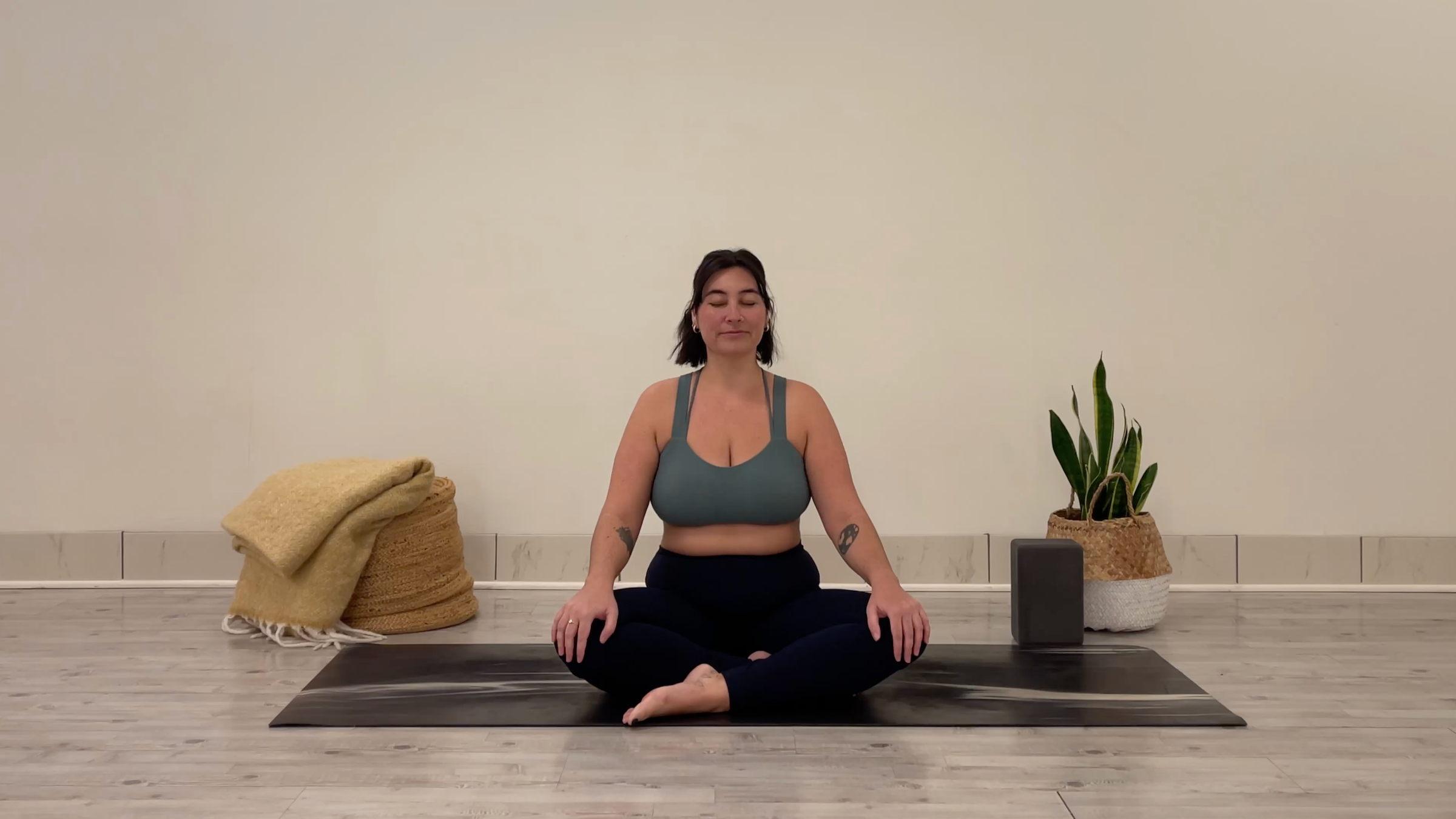 Yoga teacher Taylor Lorenz in Easy Pose, part of her yoga practice to beat the winter blues