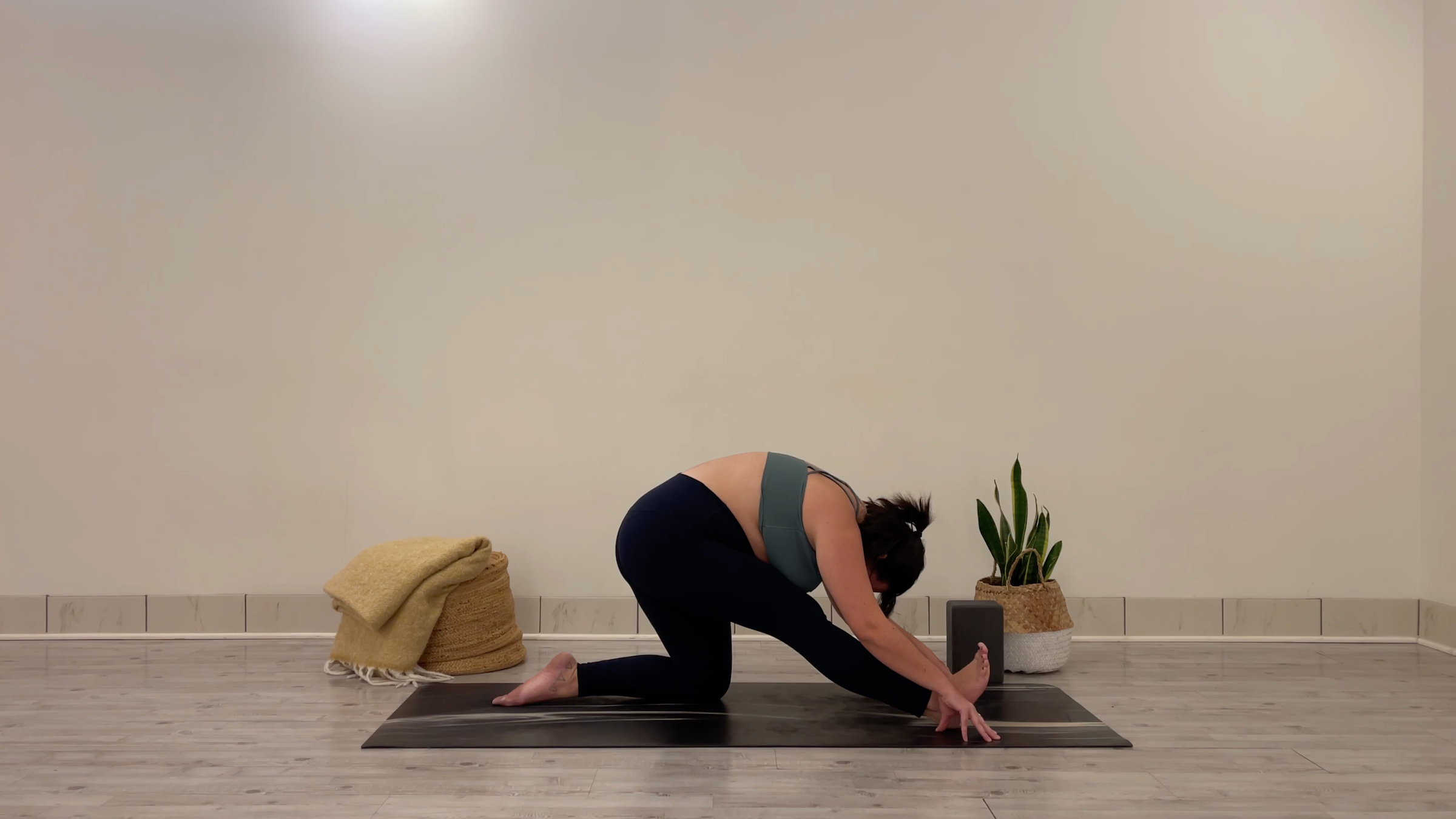 Yoga teacher Taylor Lorenz in Half Split, part of her yoga practice to beat the winter blues