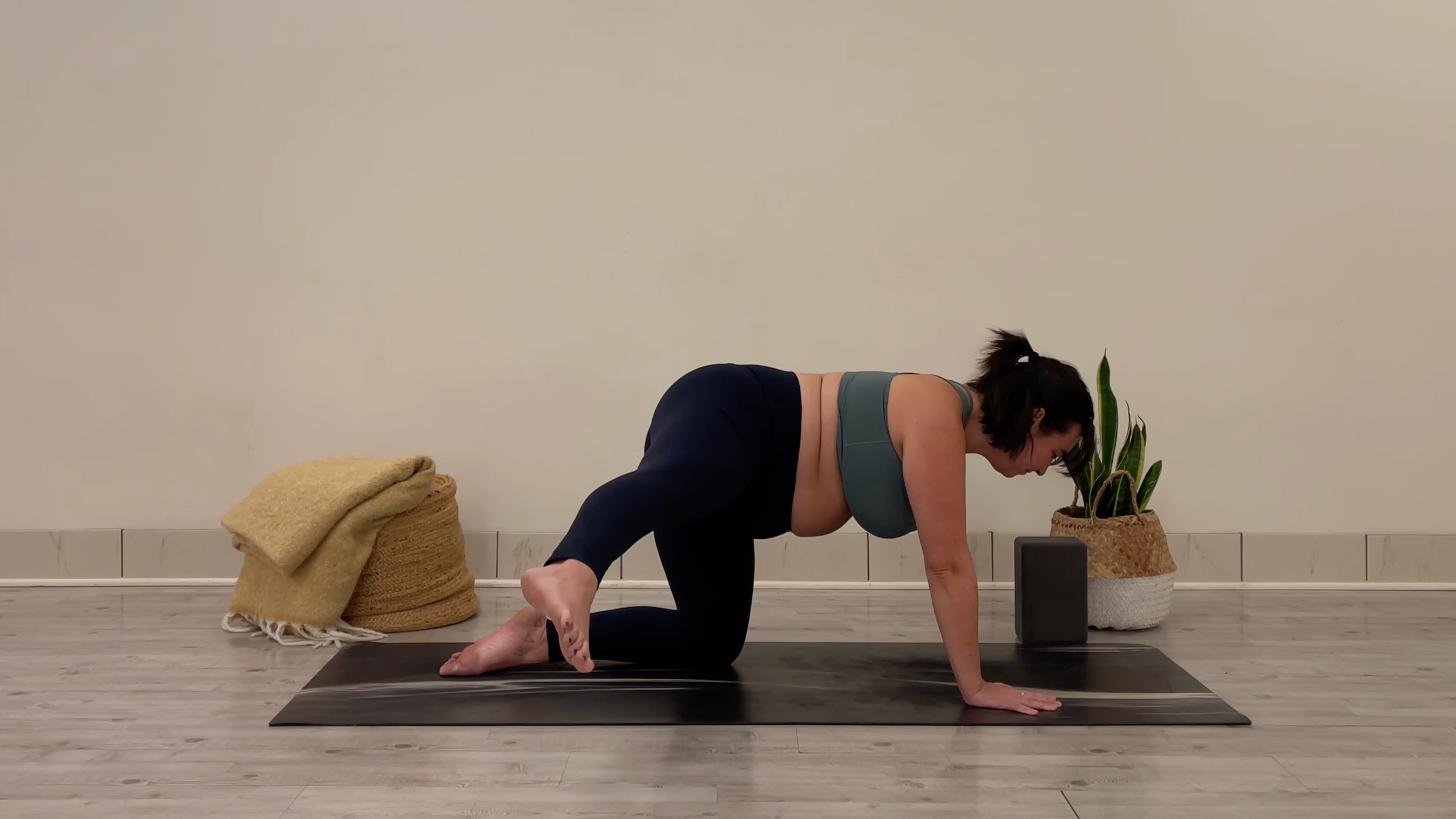 Yoga teacher Taylor Lorenz prepping for Thread the Needle, part of her yoga practice to beat the winter blues