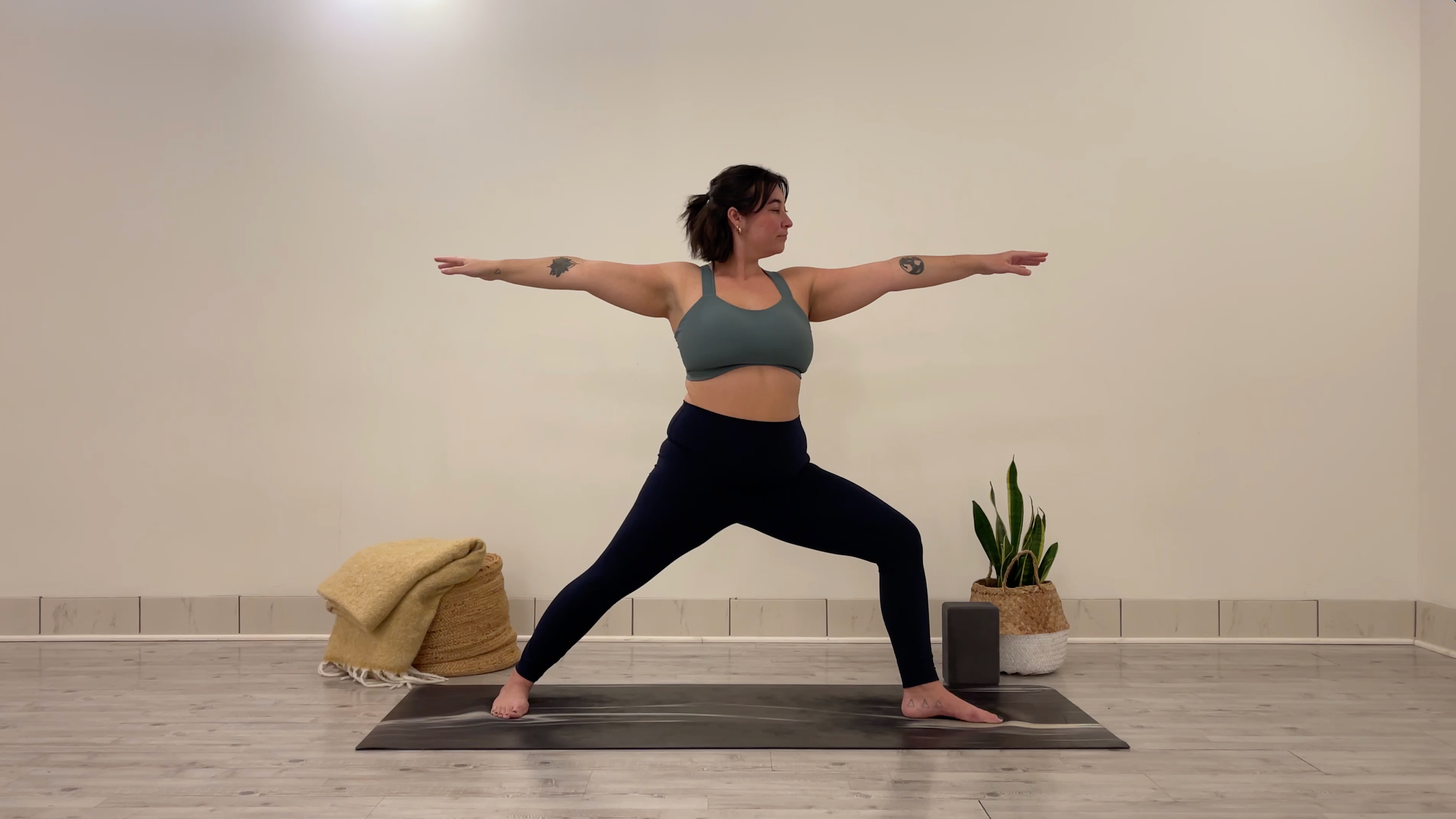 Yoga teacher Taylor Lorenz in Warrior 2, part of her yoga practice to beat the winter blues