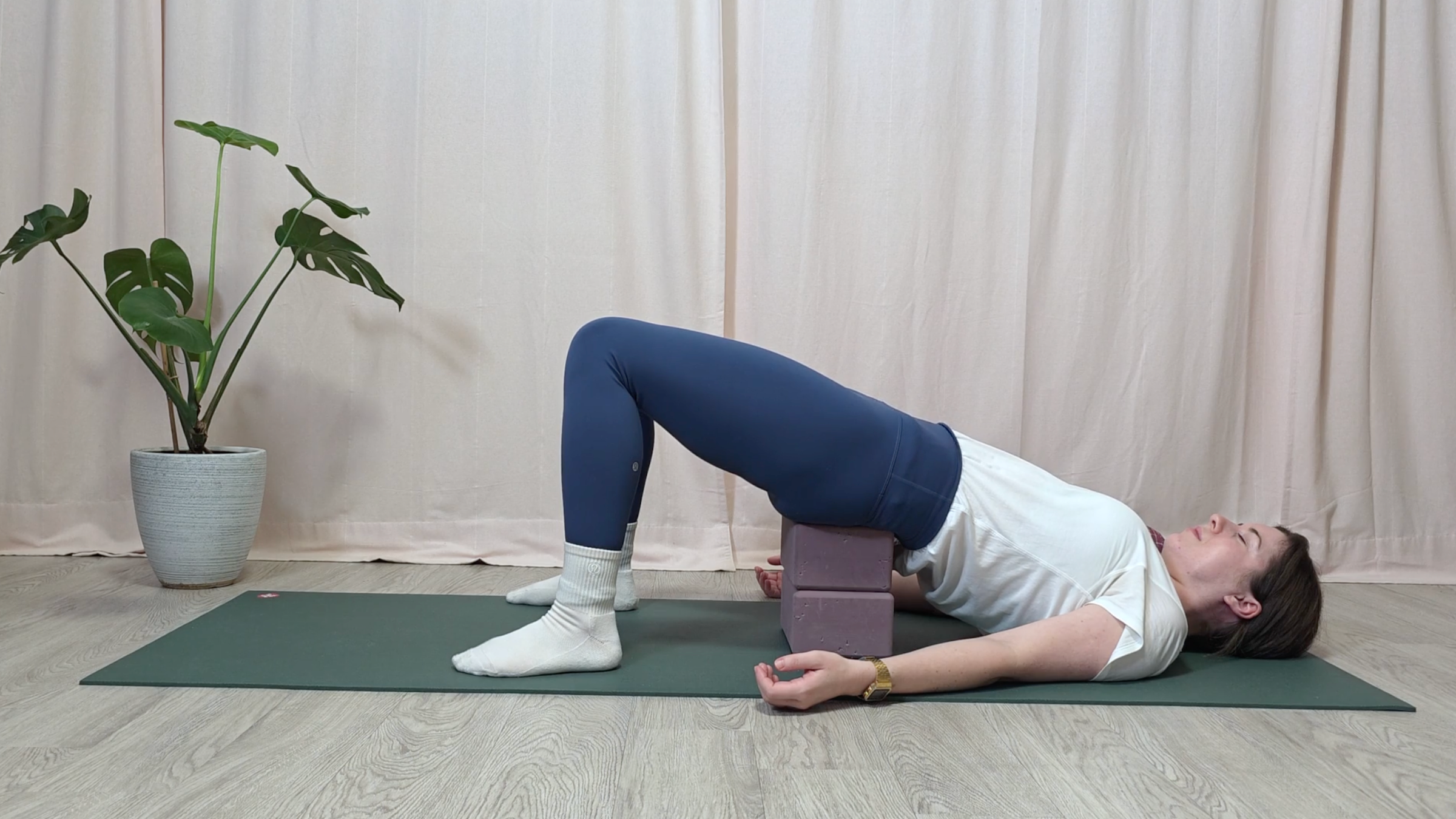 Yoga teacher Katie McGrath in Supported Bridge Pose, part of her yin yoga for stress practice