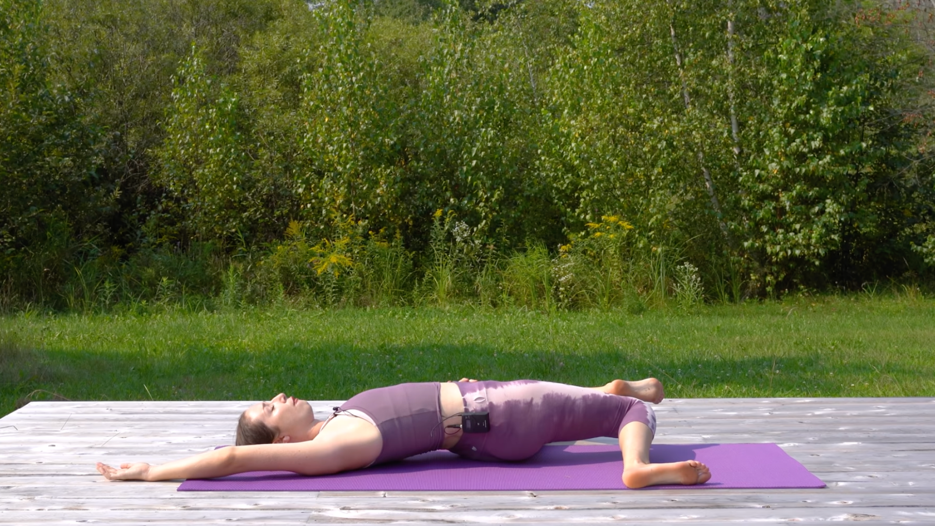 Woman lying on her back with her knees resting toward one side