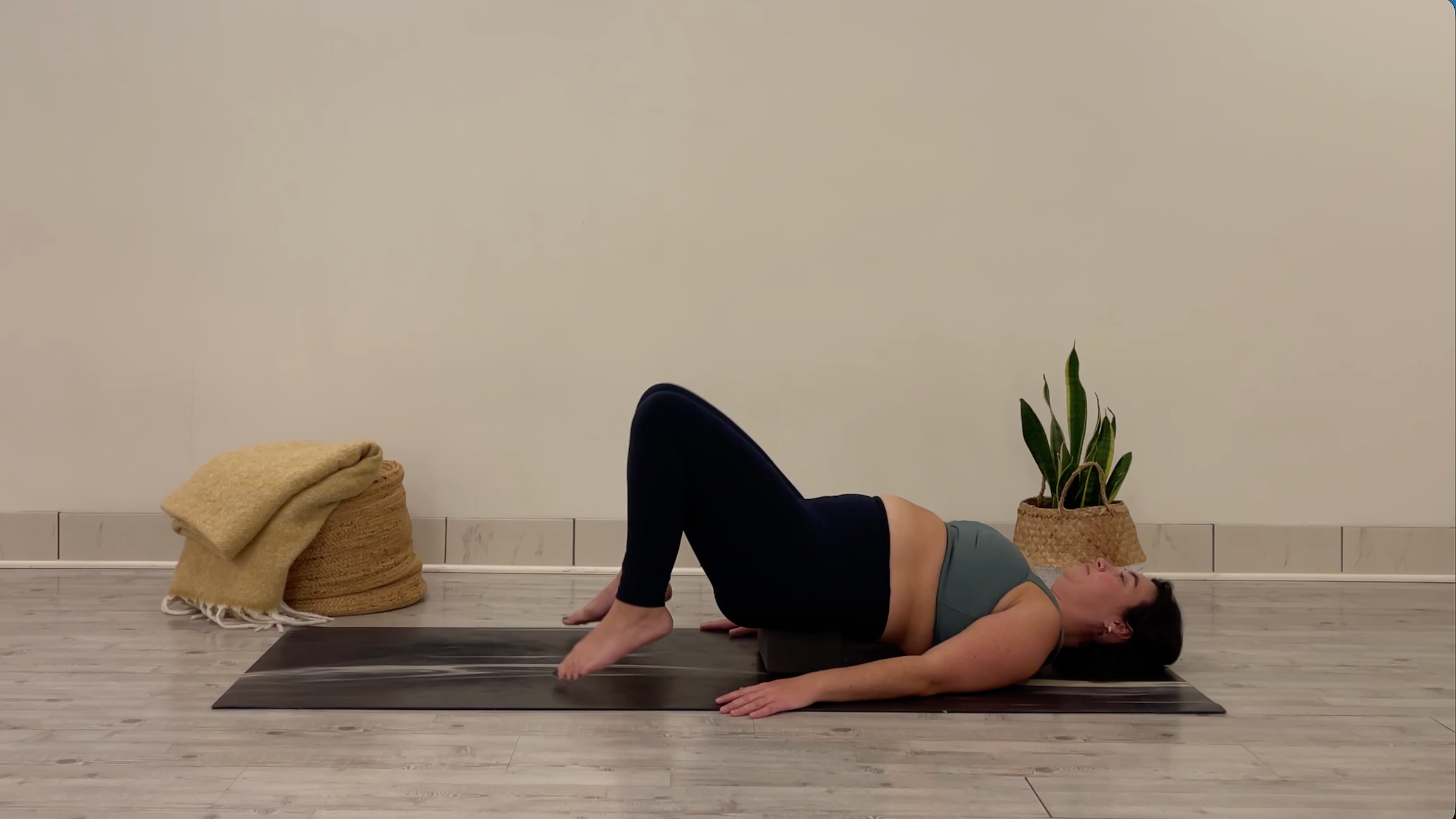 Teacher Taylor Lorenz in Supported Bridge Pose