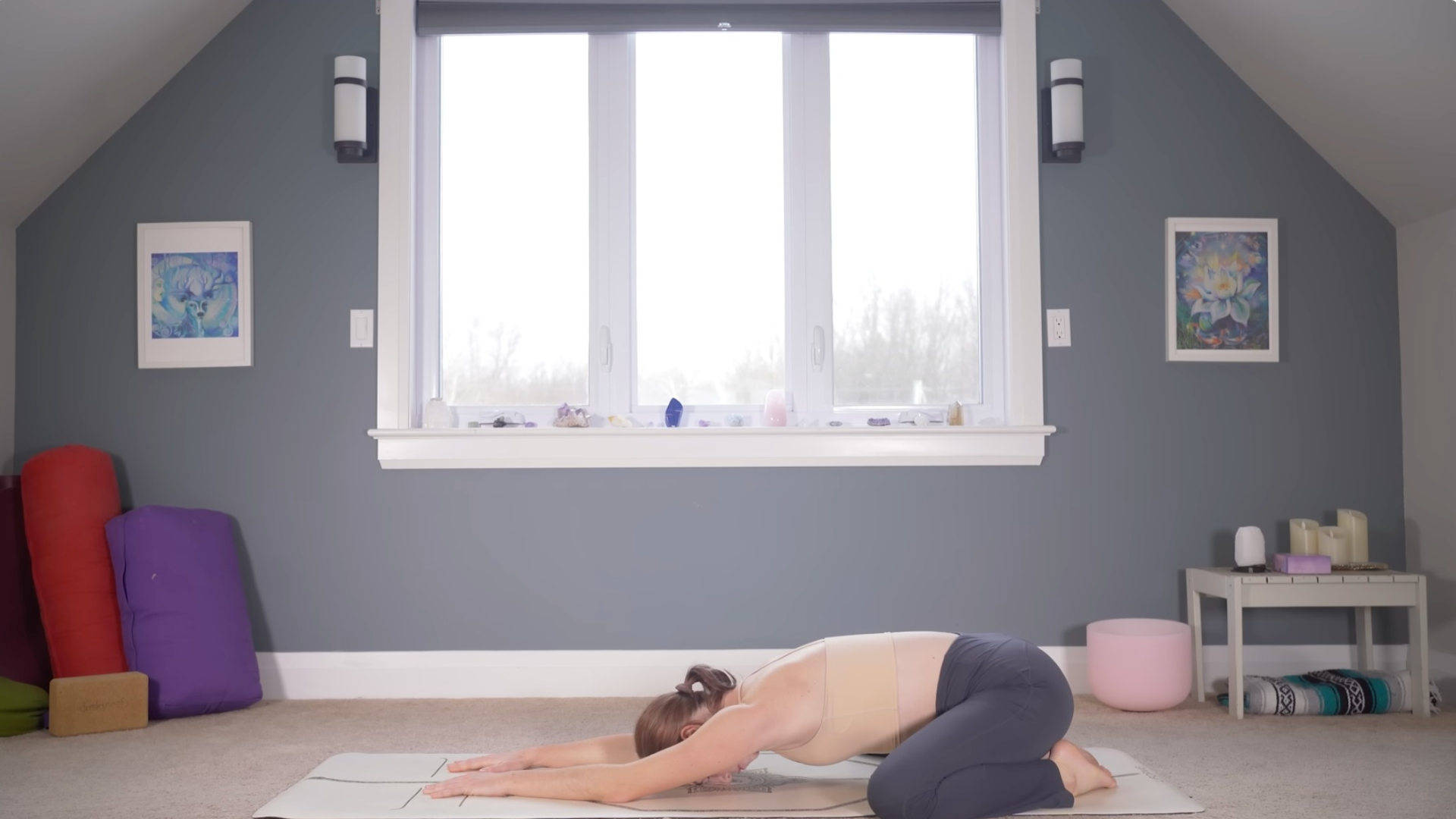 Woman in Child's Pose with her forehead on the mat