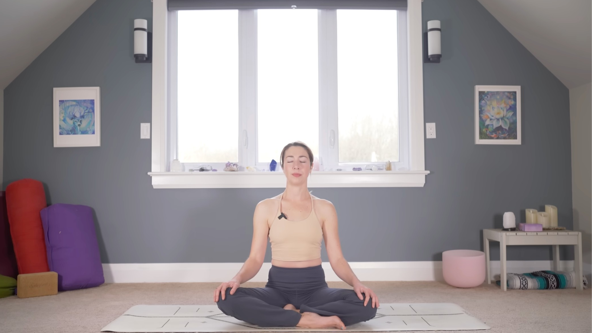 Woman sitting cross-legged on a yoga mat