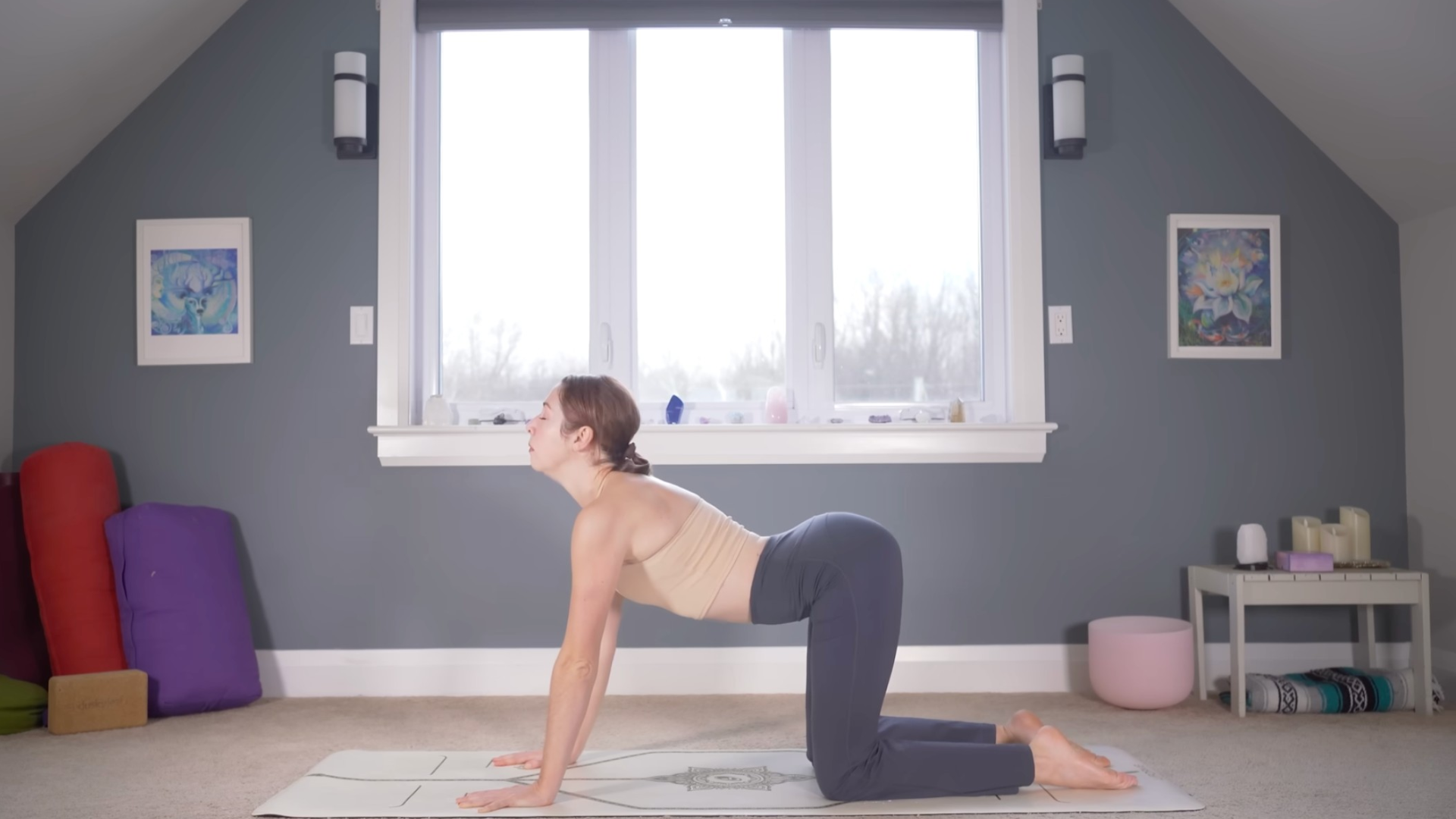 Woman kneeling on hands and knees and arching her back