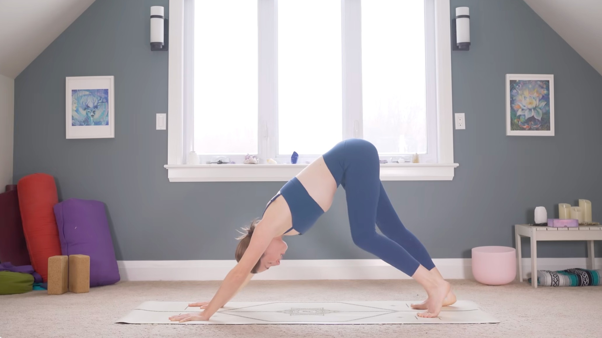 Woman in Downward-Facing Dog on a yoga mat