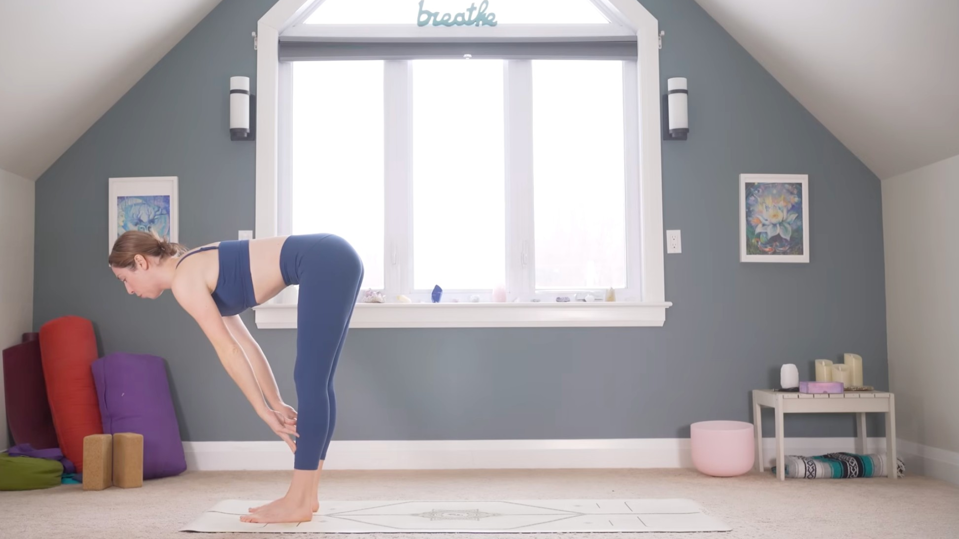 Woman leaning forward with her hands on her thighs