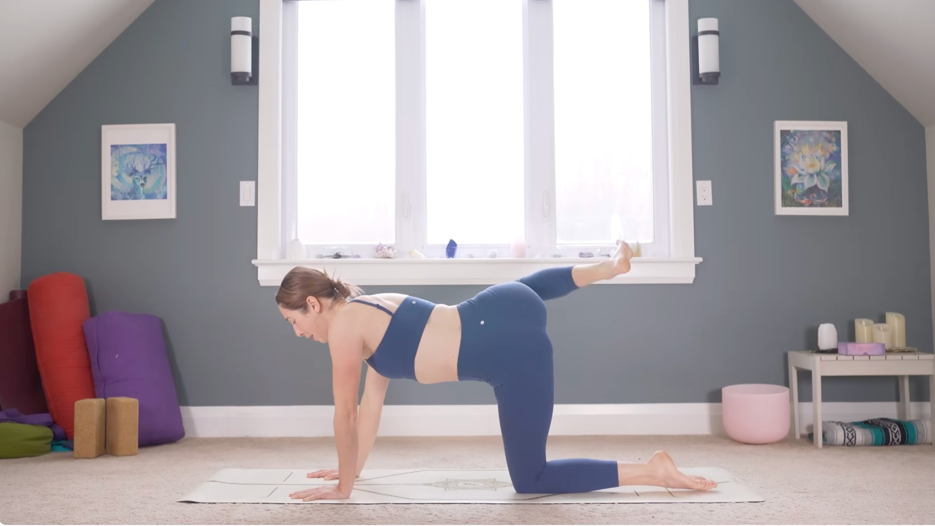 Woman on hands and knees on a mat