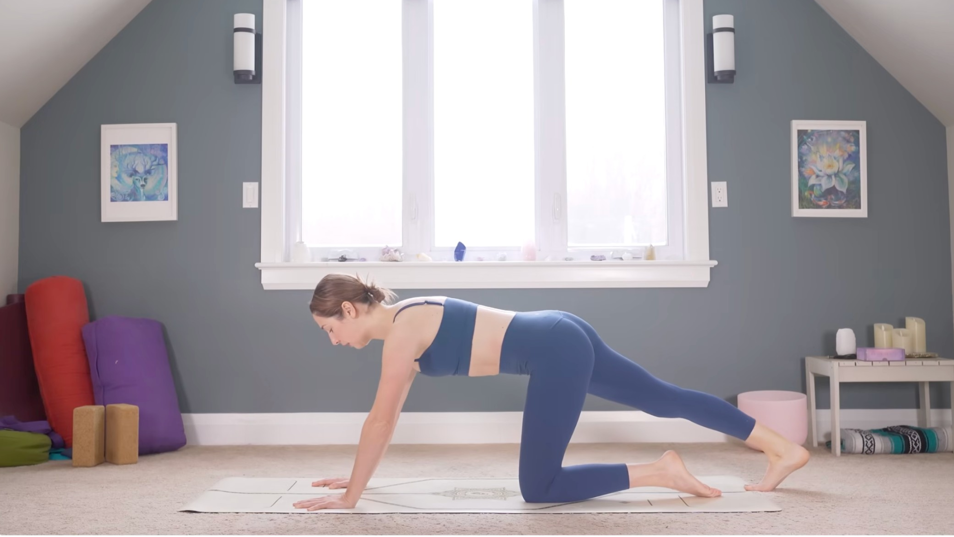 Woman kneeling on a mat with one leg extended straight behind her with her right toes on the mat