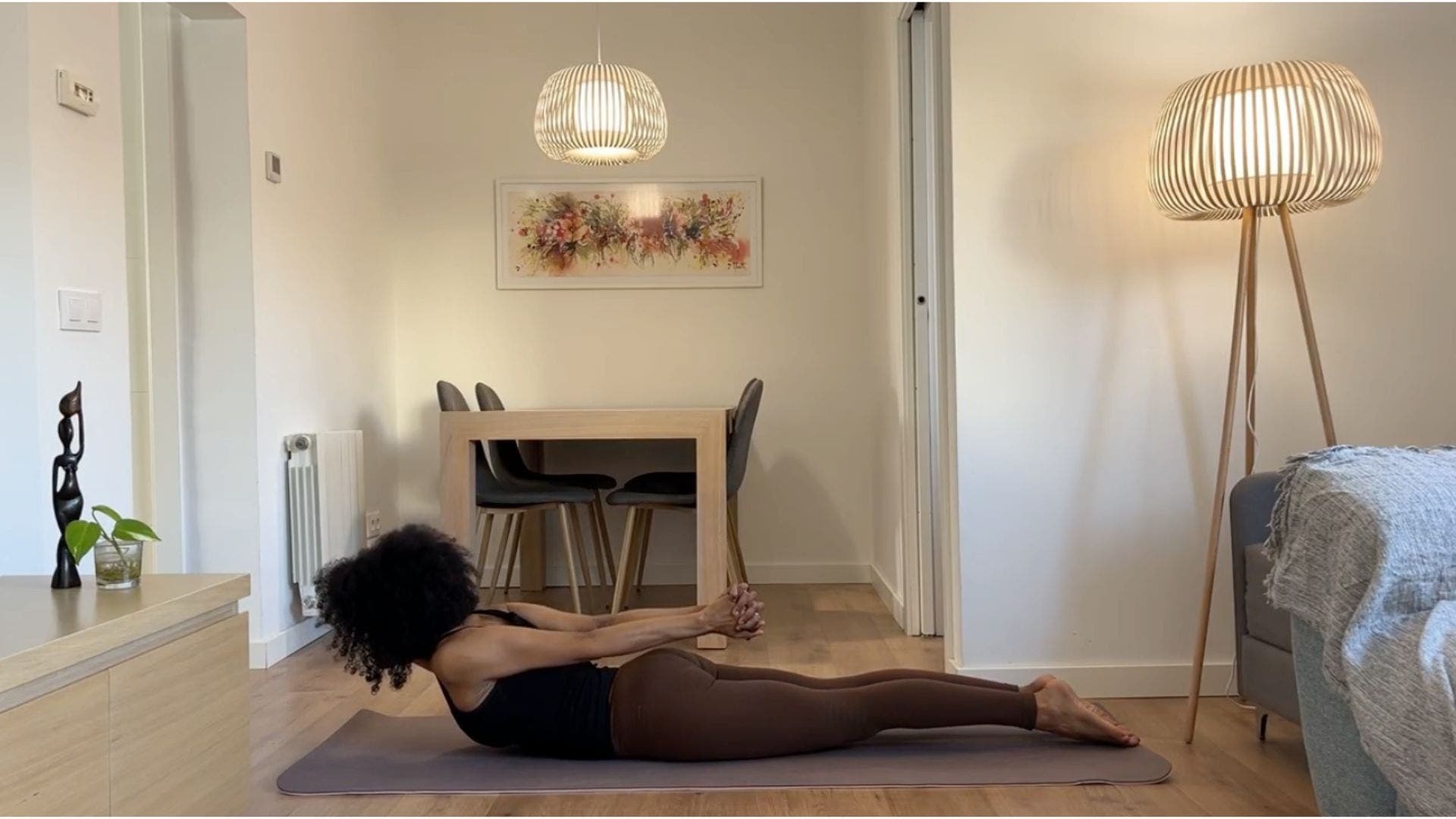 Yoga teacher practicing Locust Pose.