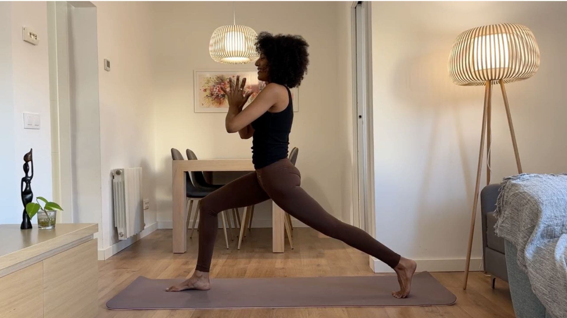 Yoga teacher practicing High Lunge.