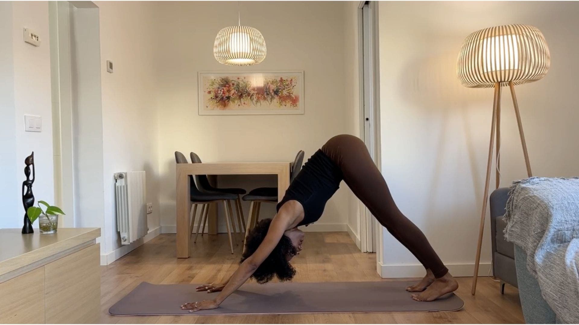 Yoga teacher practicing Downward Dog.
