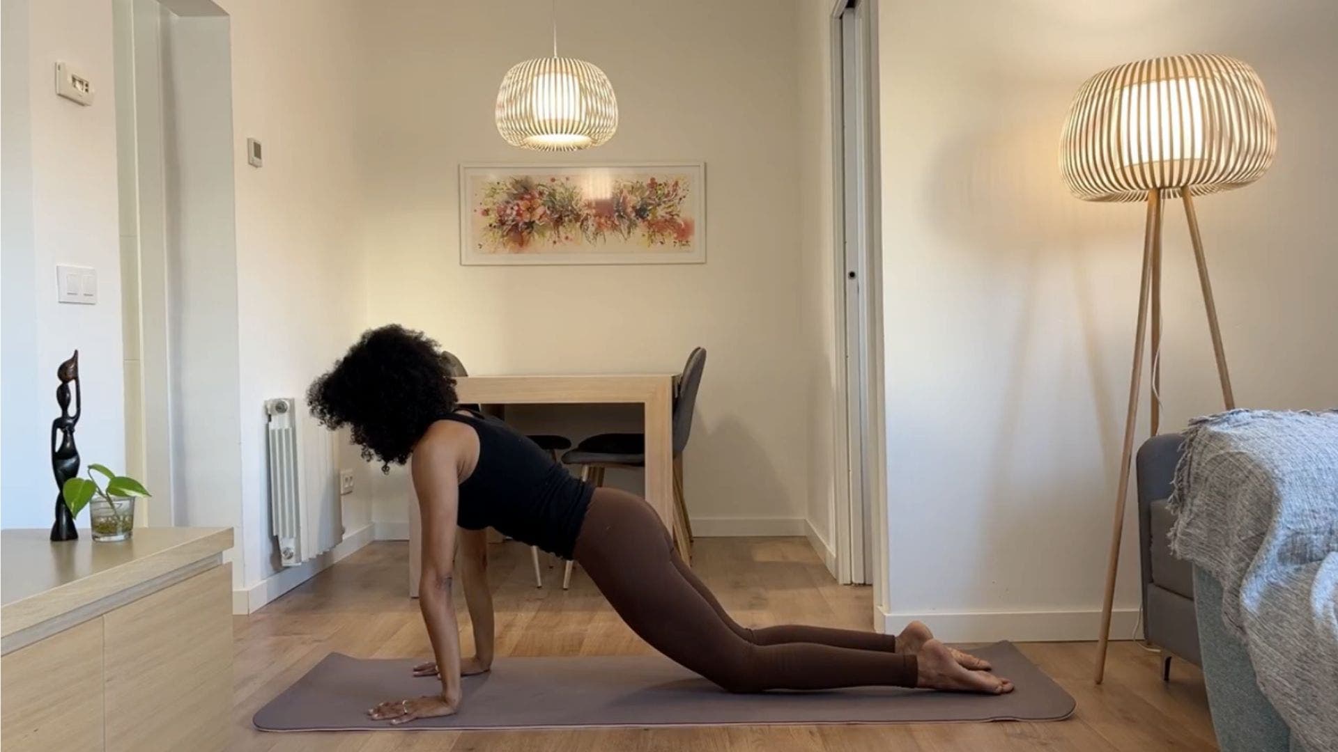 Yoga teacher practicing knees-down Plank.