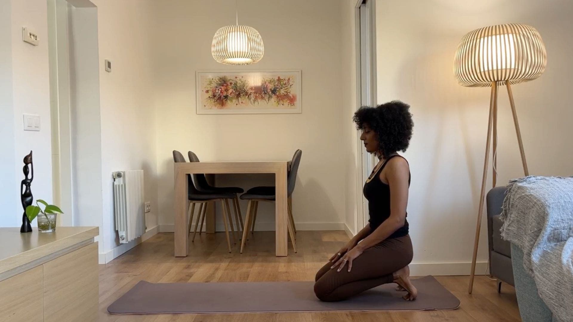 Yoga teacher practicing Thunderbolt pose.