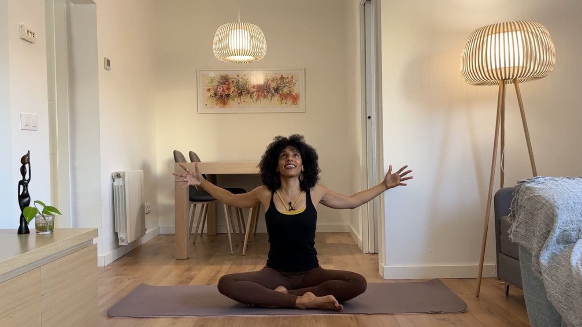 Yoga teacher practicing seated chest stretch.