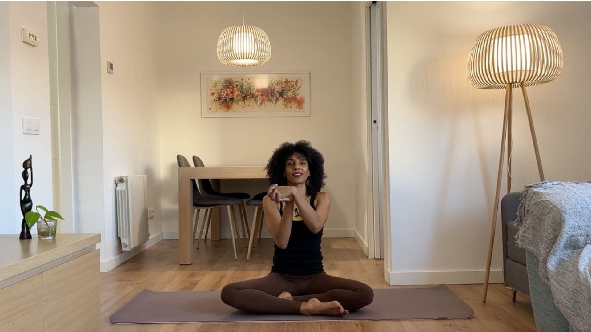 Yoga teacher practicing seated wrist circles.