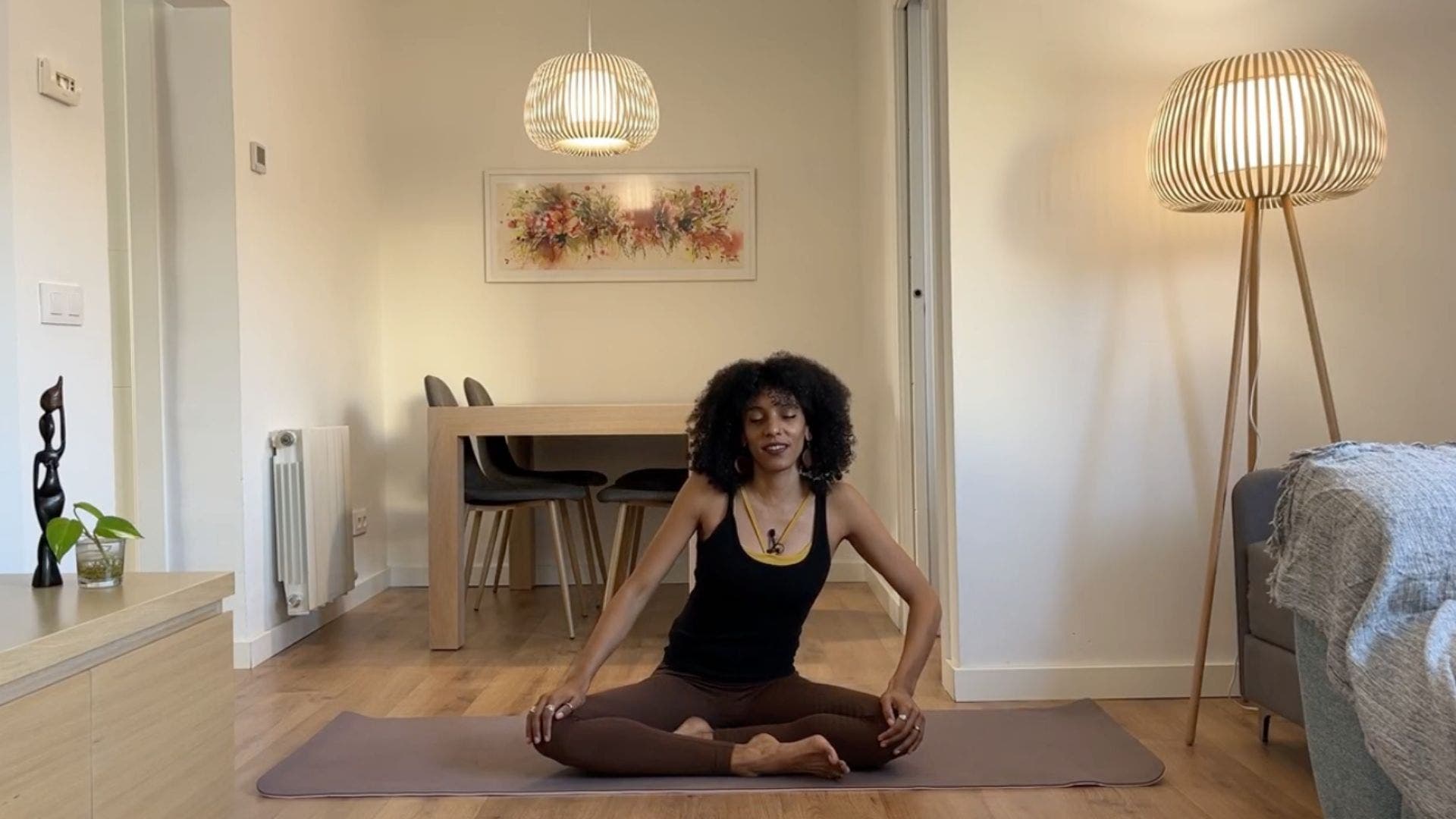 Yoga teacher practicing seated torso circles.
