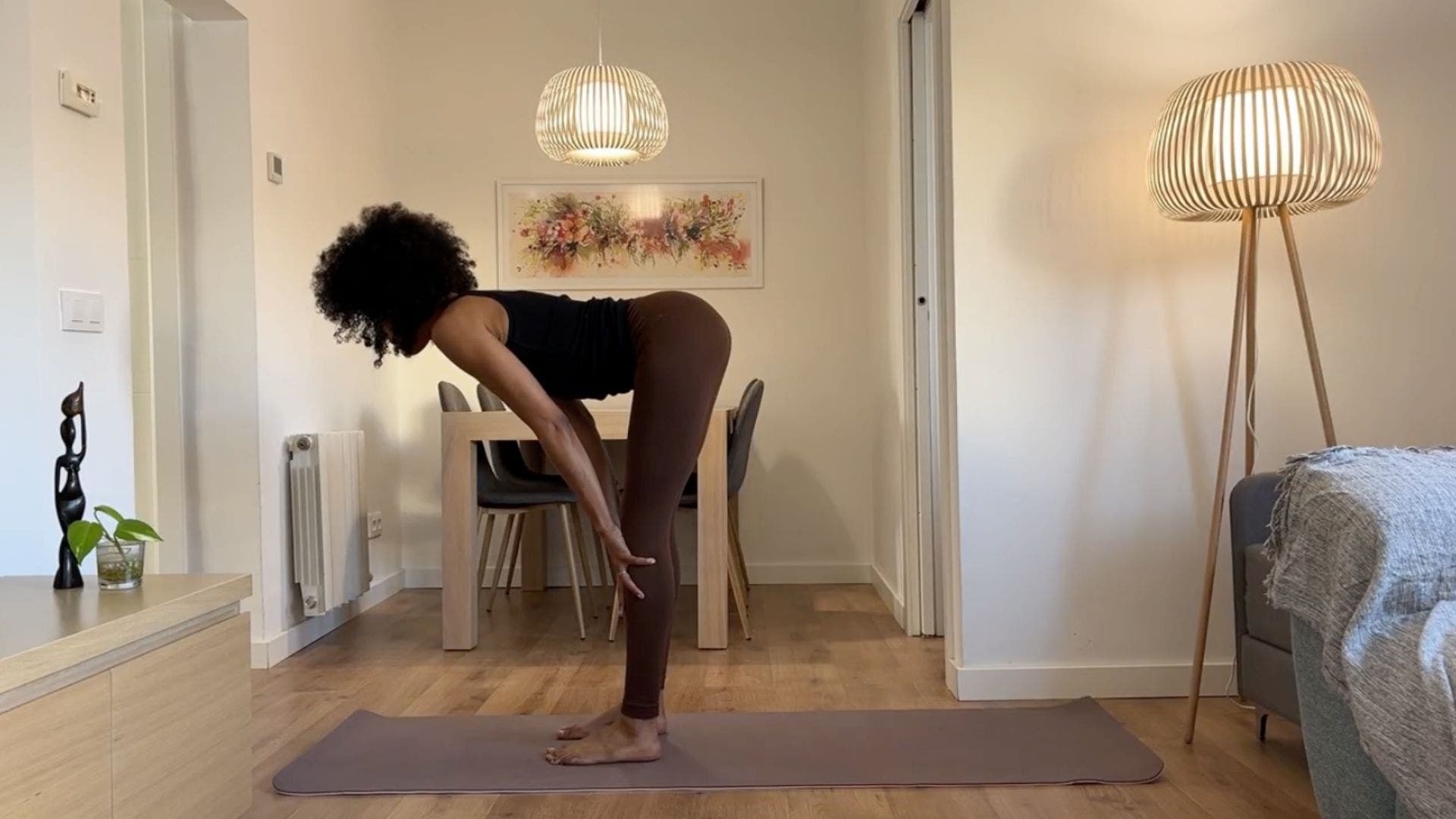 Yoga teacher practicing Standing Half Forward Bend.