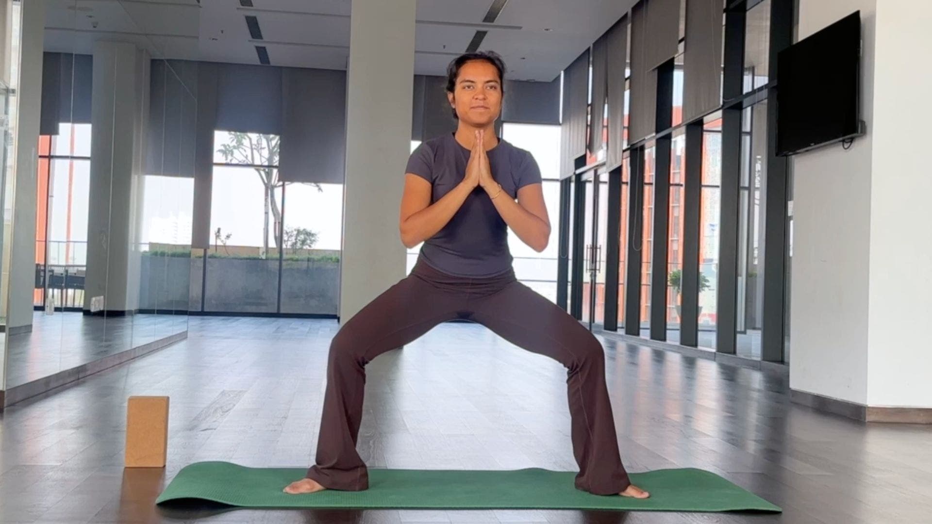 Yoga instructor practicing Goddess Pose.
