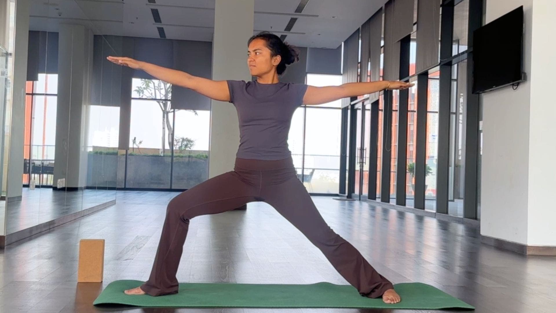 Yoga instructor practicing Warrior 2.