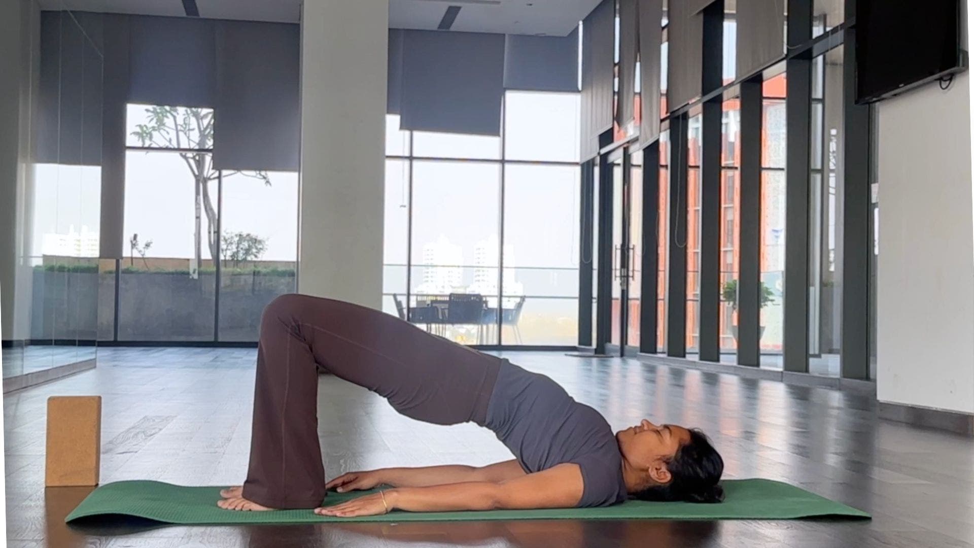 Yoga instructor practicing Bridge Pose.