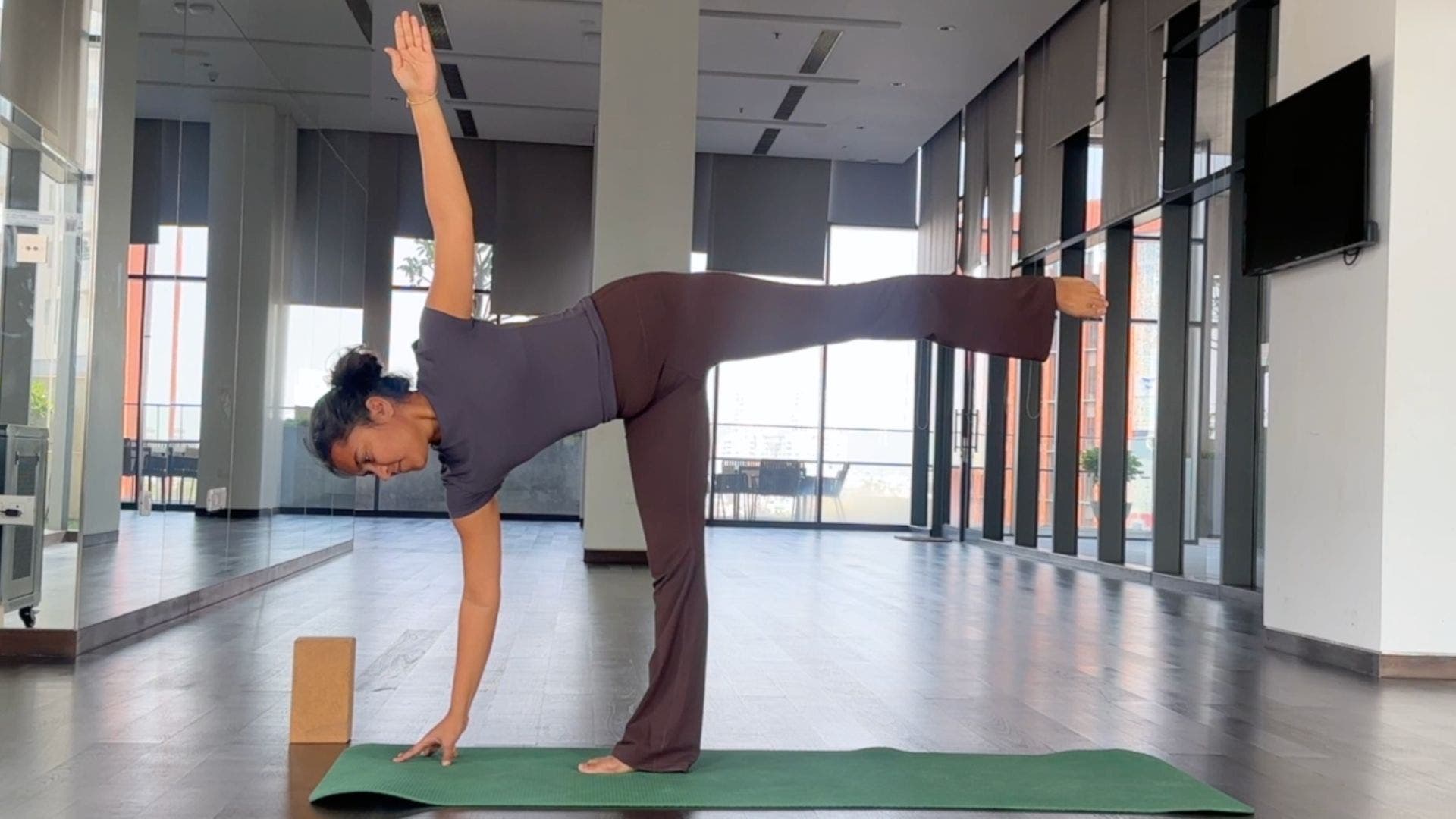 Yoga instructor practicing Half Moon Pose.