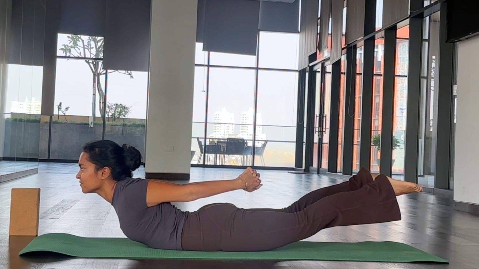 Yoga instructor practicing Locust Pose.