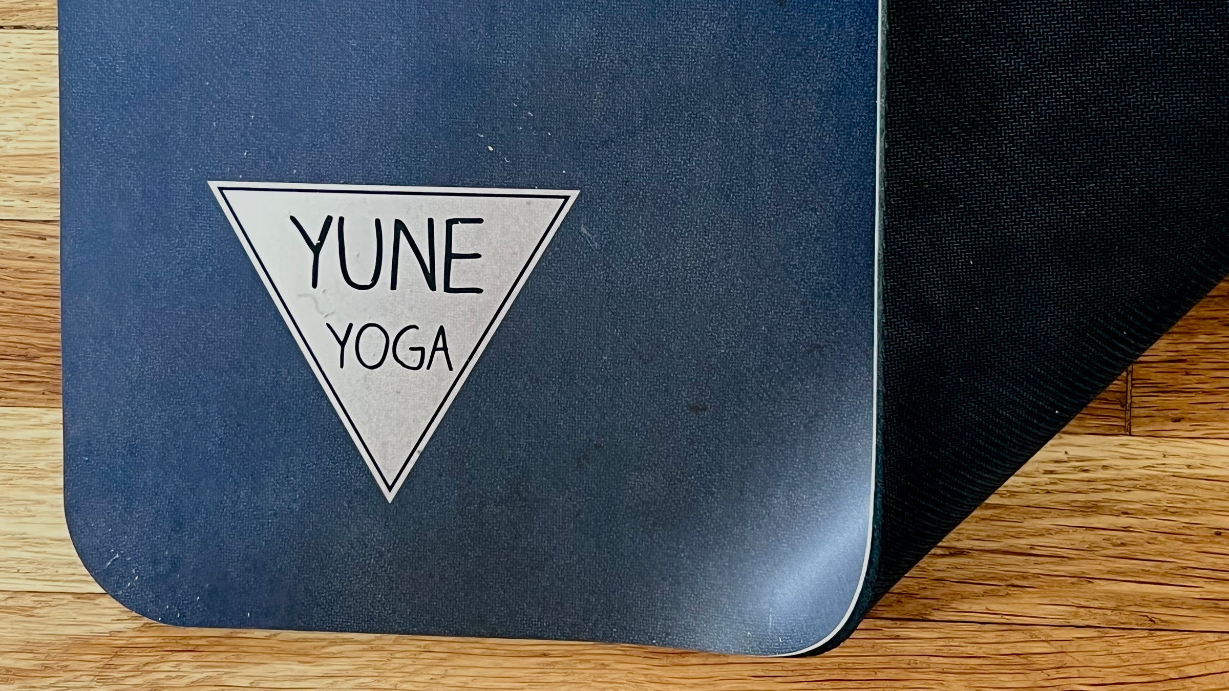 Tester image of black Yune yoga mat showing bottom and top of mat