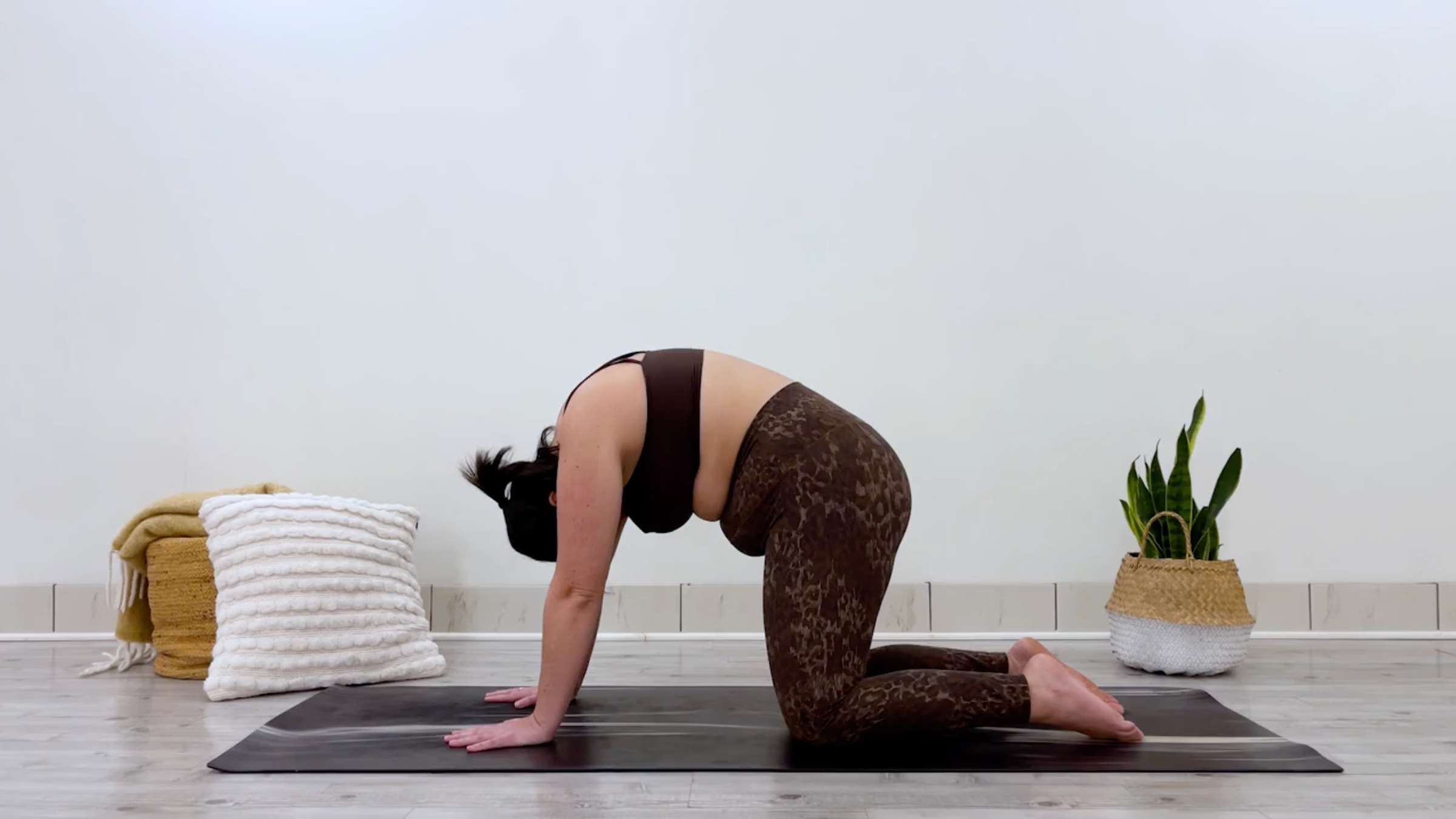 Yoga teacher Taylor Lorenz in Cat Pose, part of her bedtime yoga practice