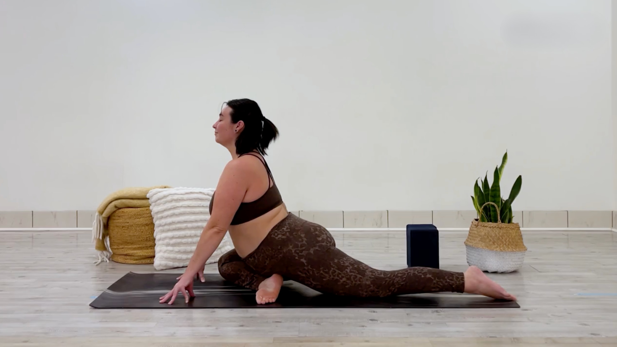 Yoga teacher Taylor Lorenz in Pigeon Pose, part of her self-love yoga practice