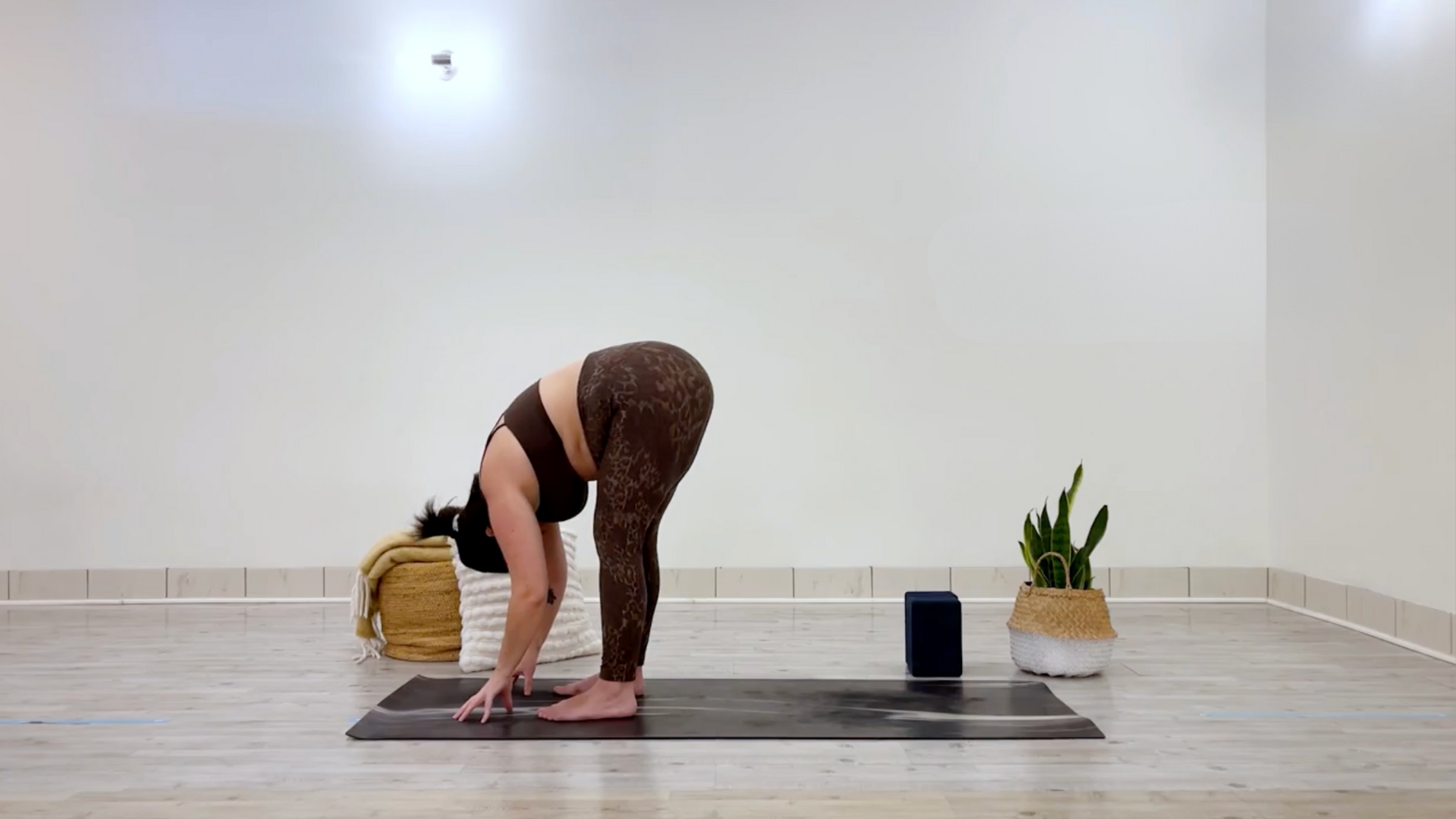 Yoga teacher Taylor Lorenz in Standing Forward Bend, part of her self-love yoga practice