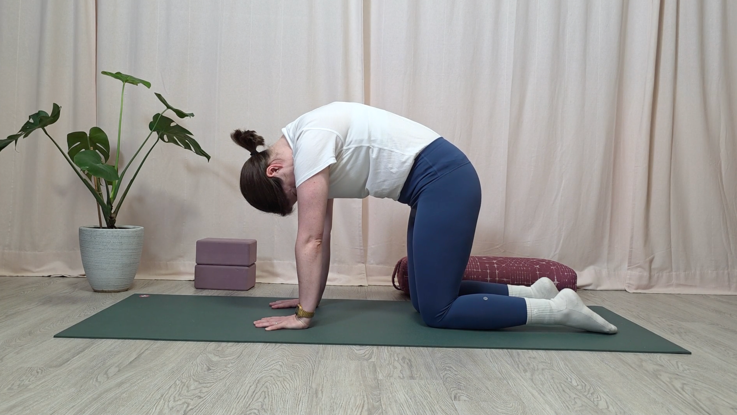 Yoga teacher Katie McGrath in Cat Pose, part of her yin yoga for neck pain practice