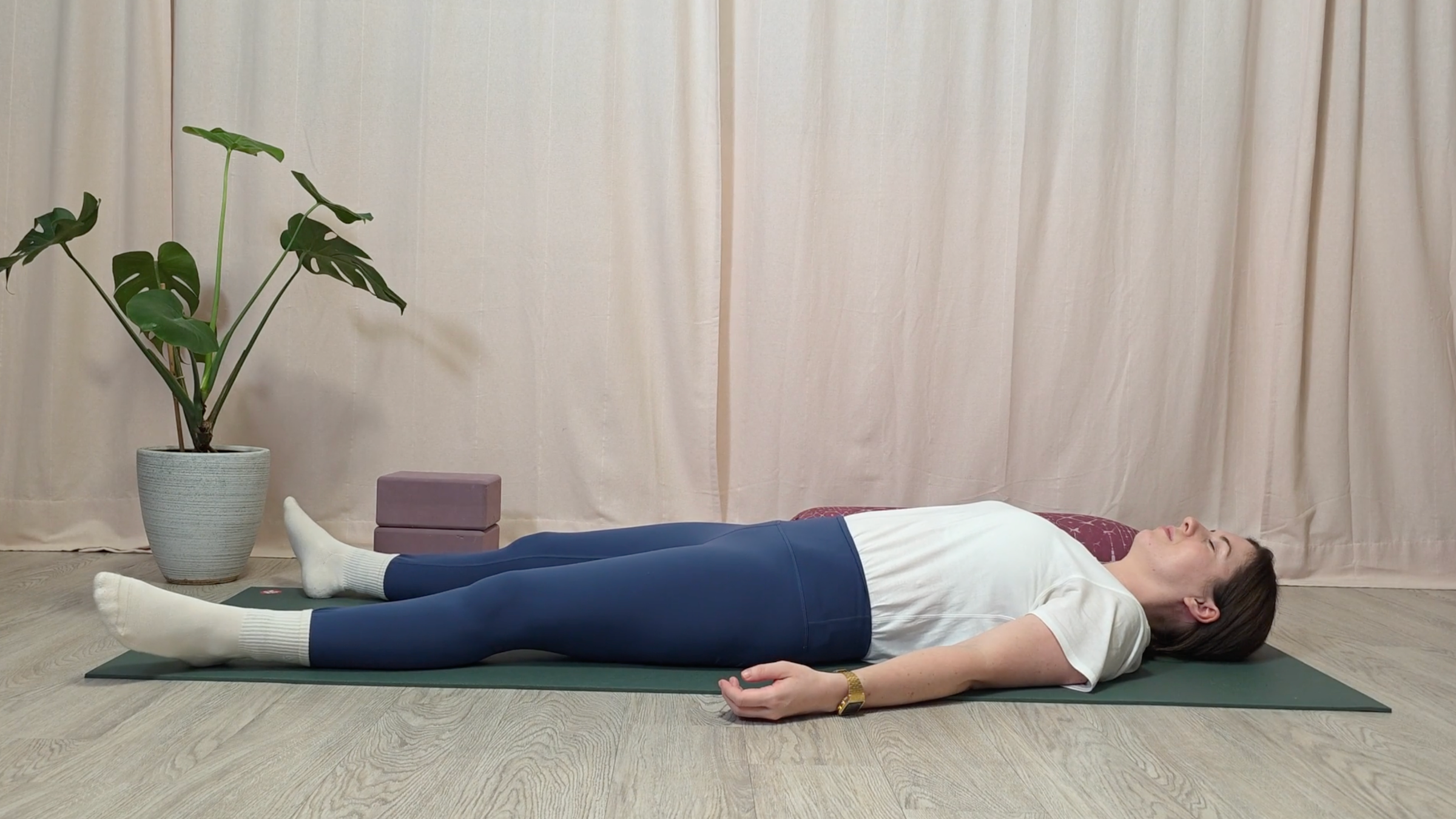 Teacher Katie McGrath in Savasana