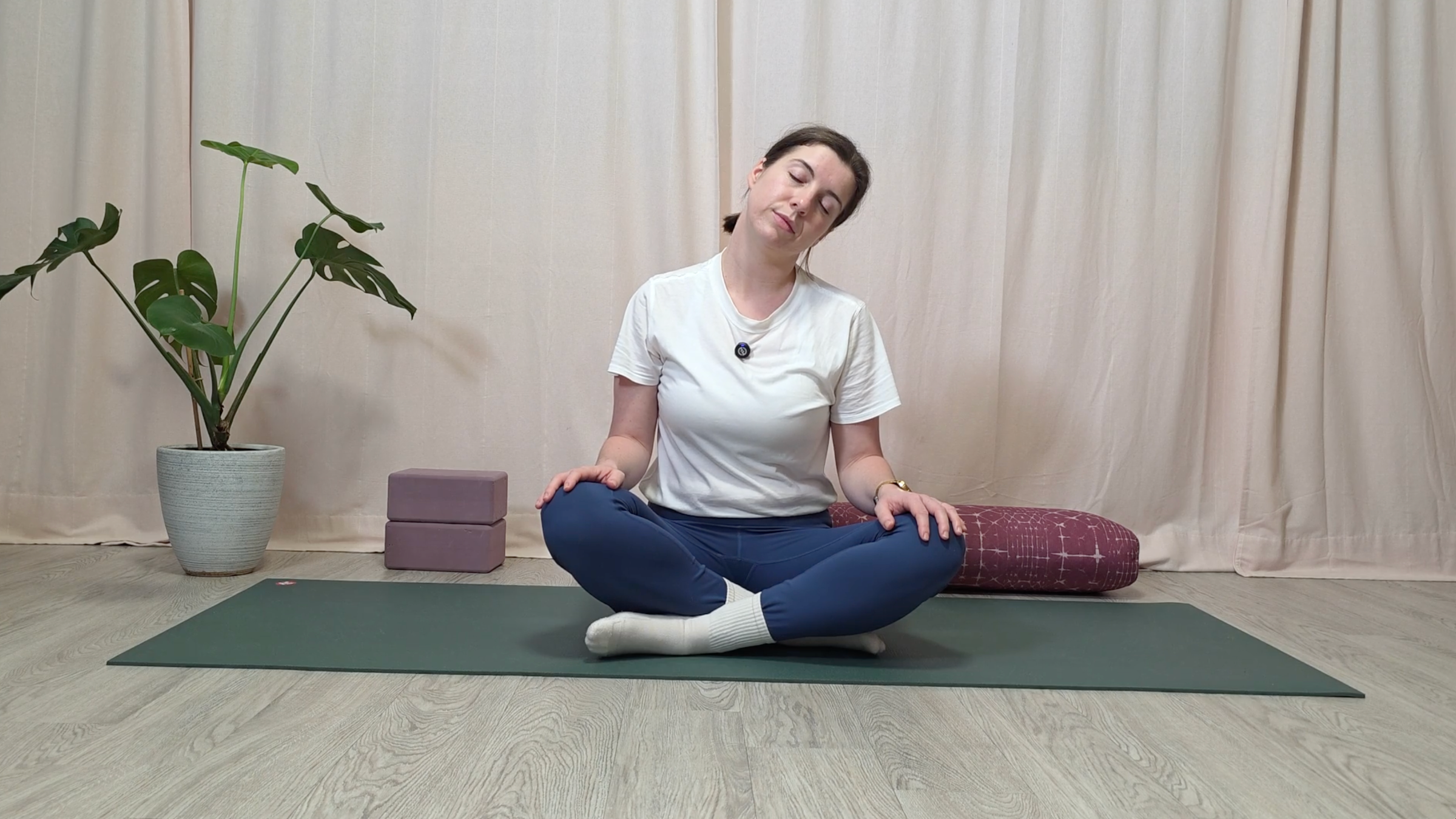 Teacher Katie McGrath doing a seated neck stretch
