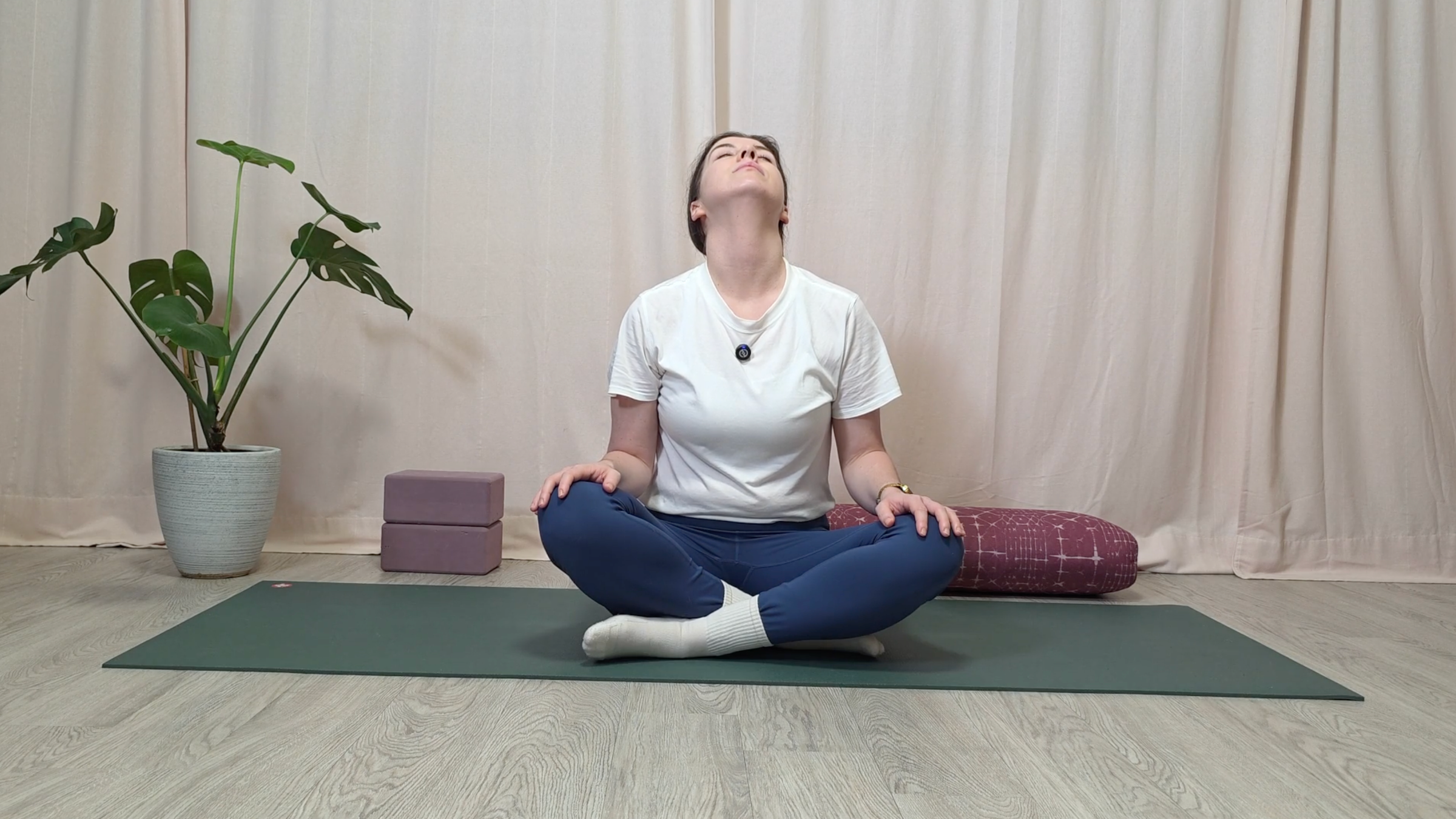 Teacher Katie McGrath in a seated pose