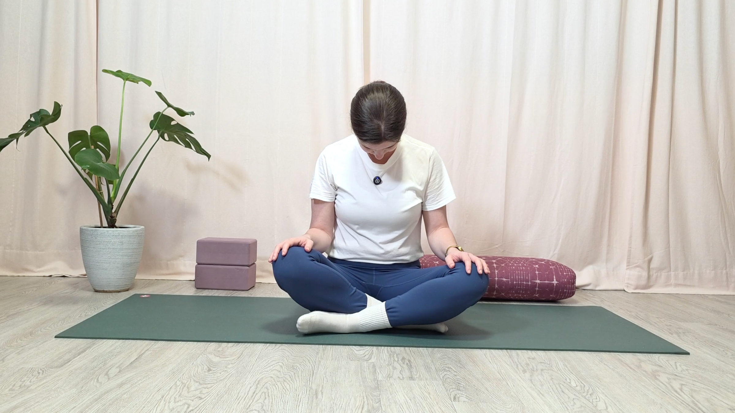 Teacher Katie McGrath doing a seated neck stretch
