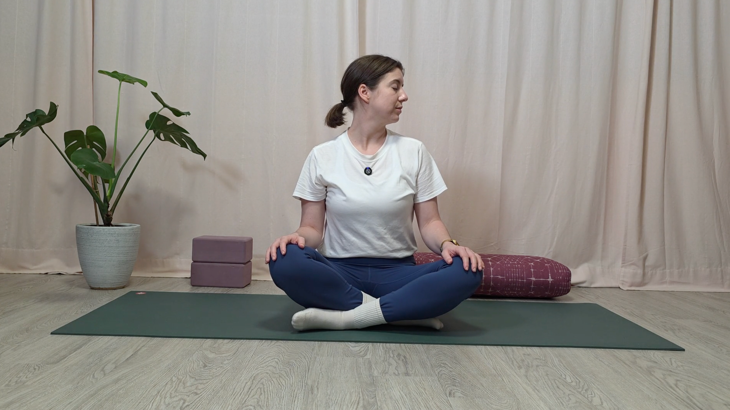 Teacher Katie McGrath doing a seated neck stretch