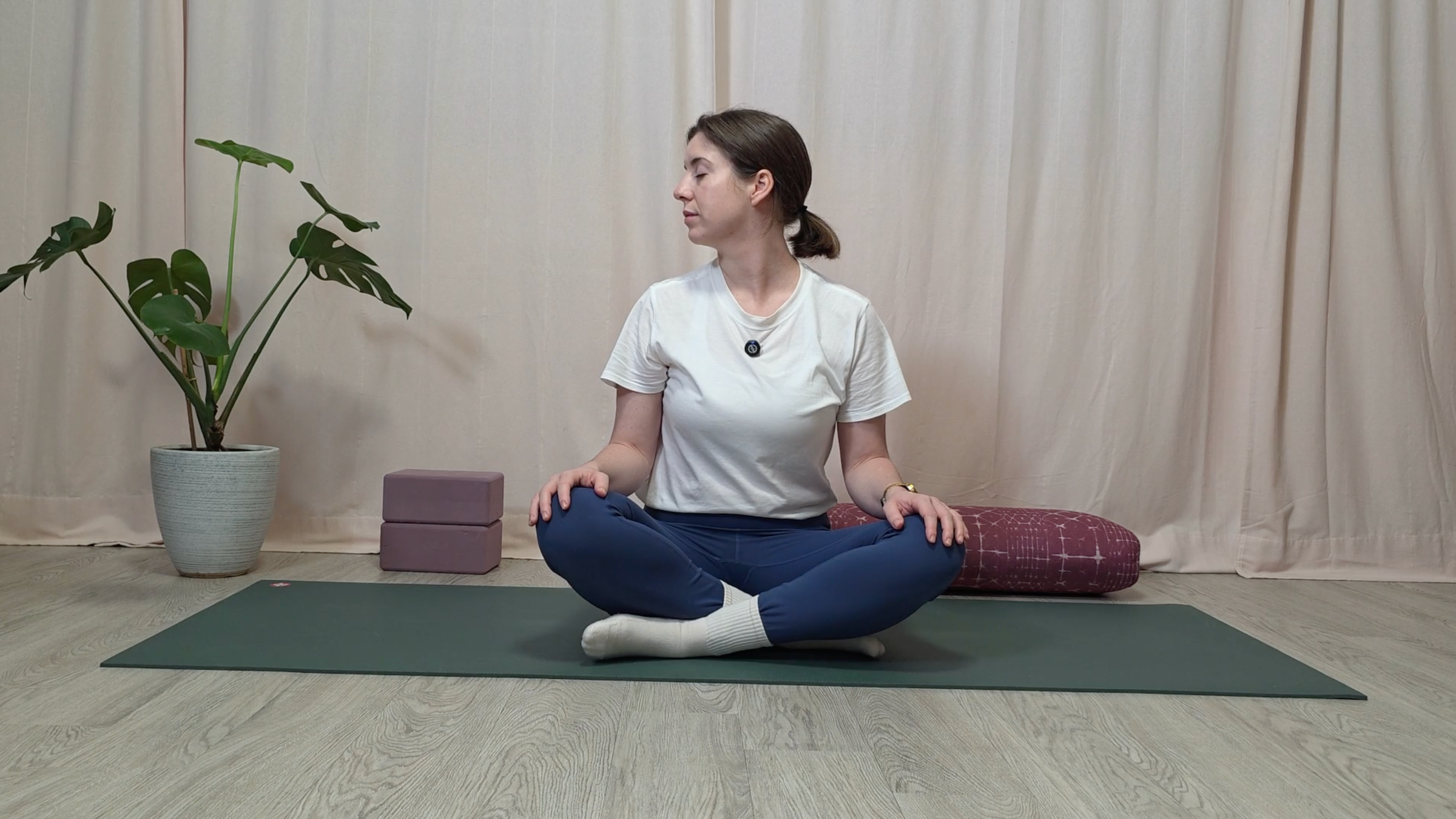 Teacher Katie McGrath in a seated pose