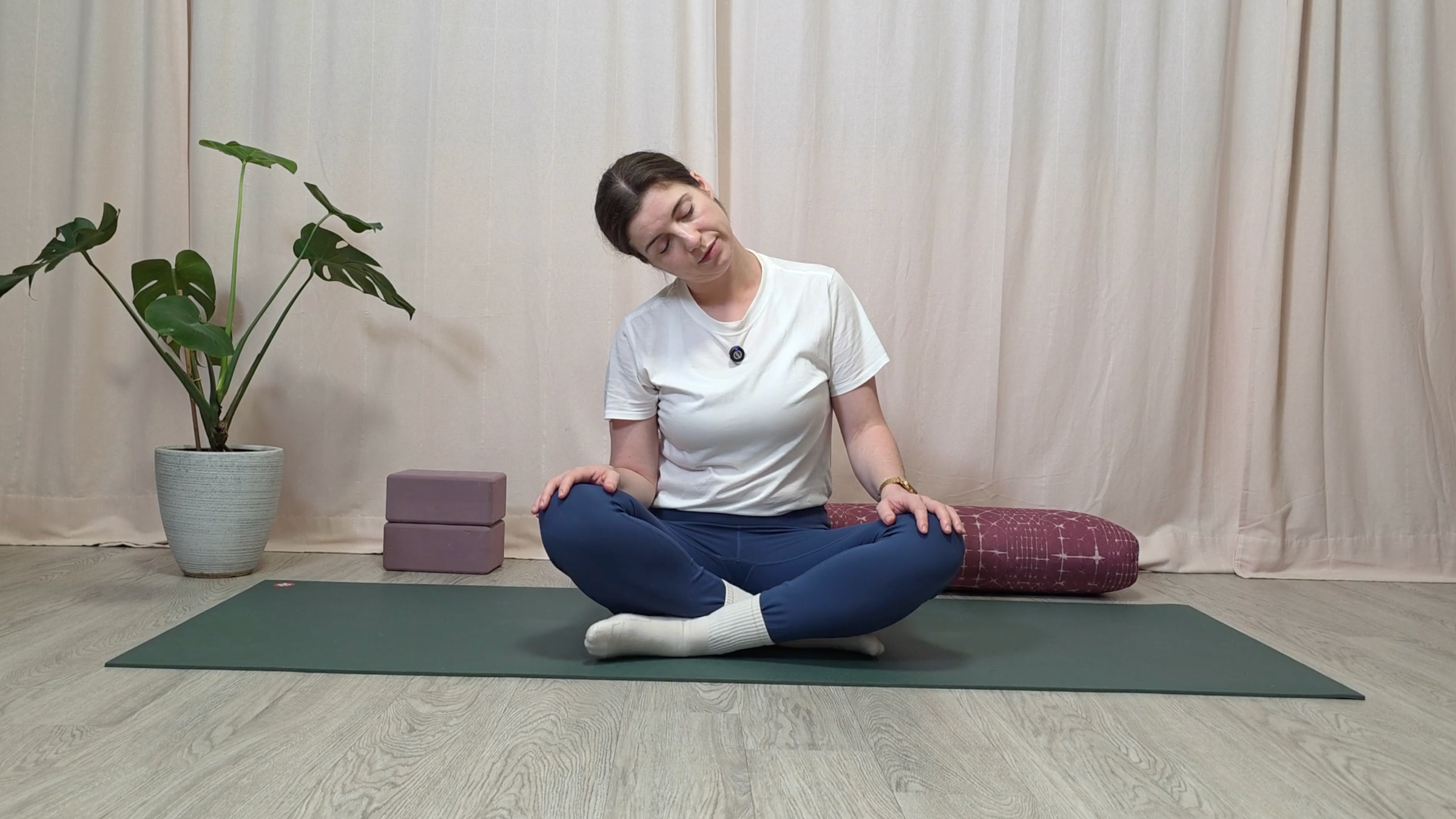 Teacher Katie McGrath doing a seated neck stretch