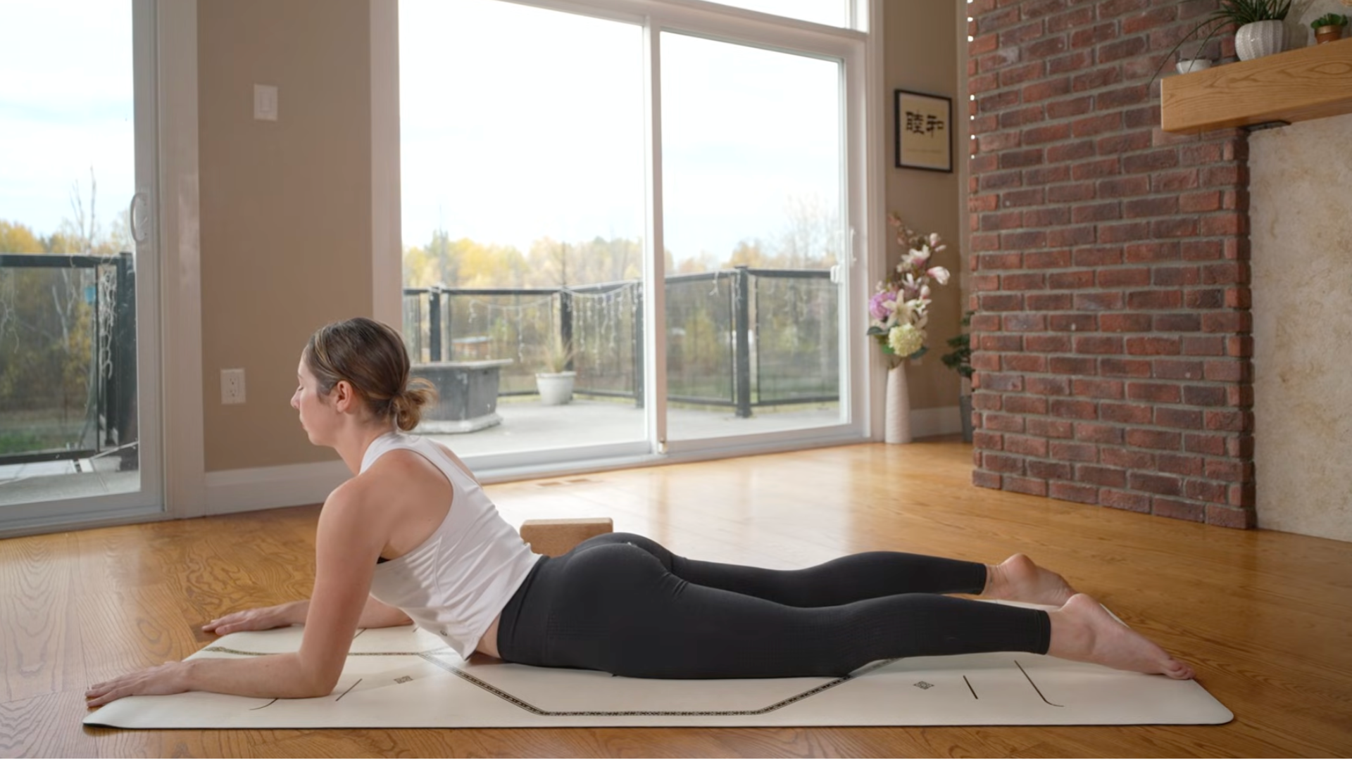 Woman lying on a mat in Sphinx Pose