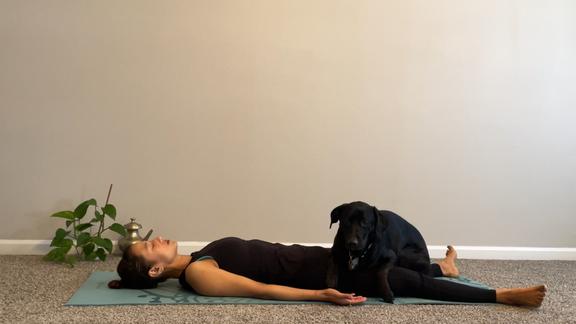 Woman lying on a mat in Savasana during a yoga for anger practice