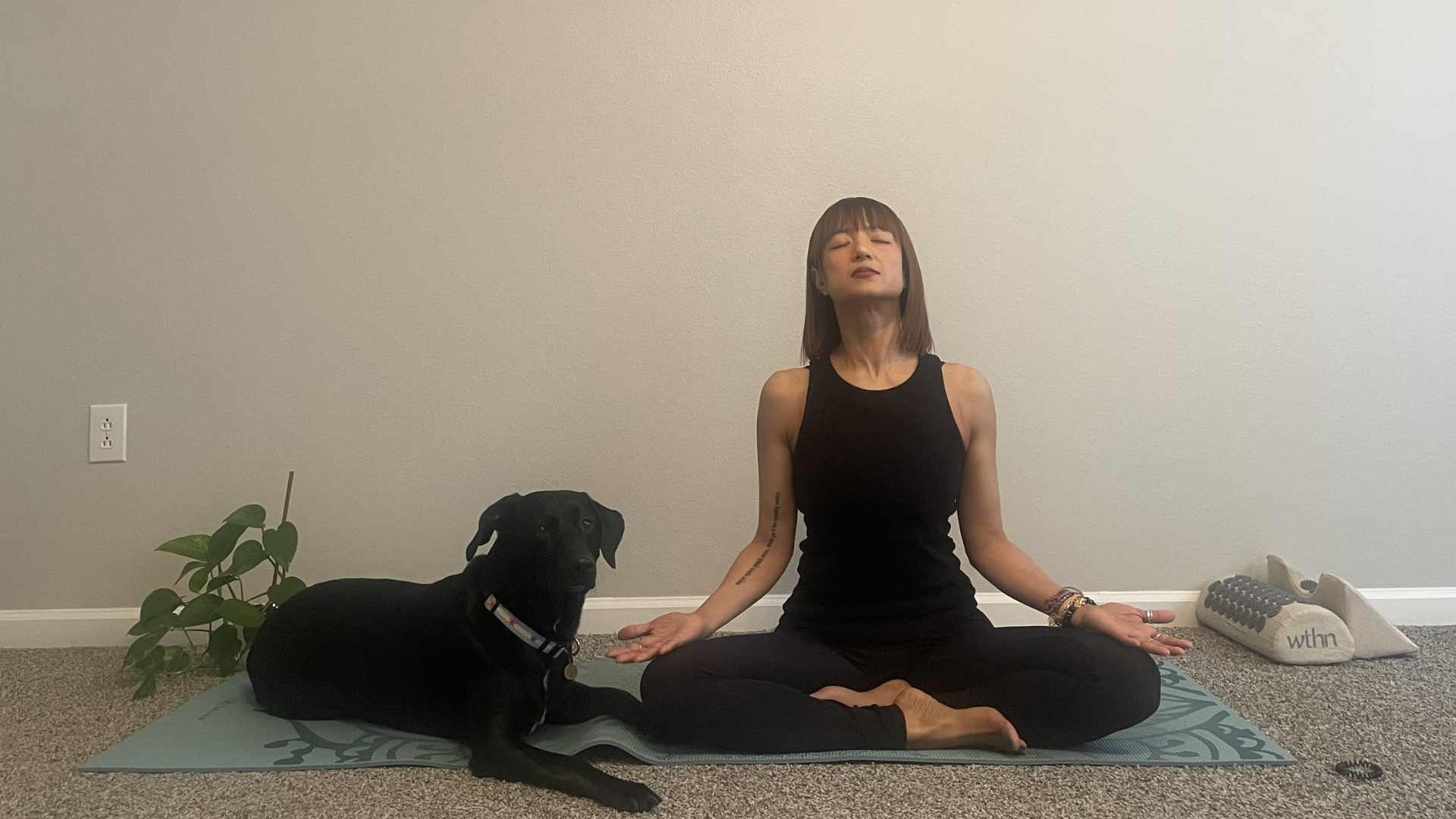 Woman sitting on a mat with her knees bent