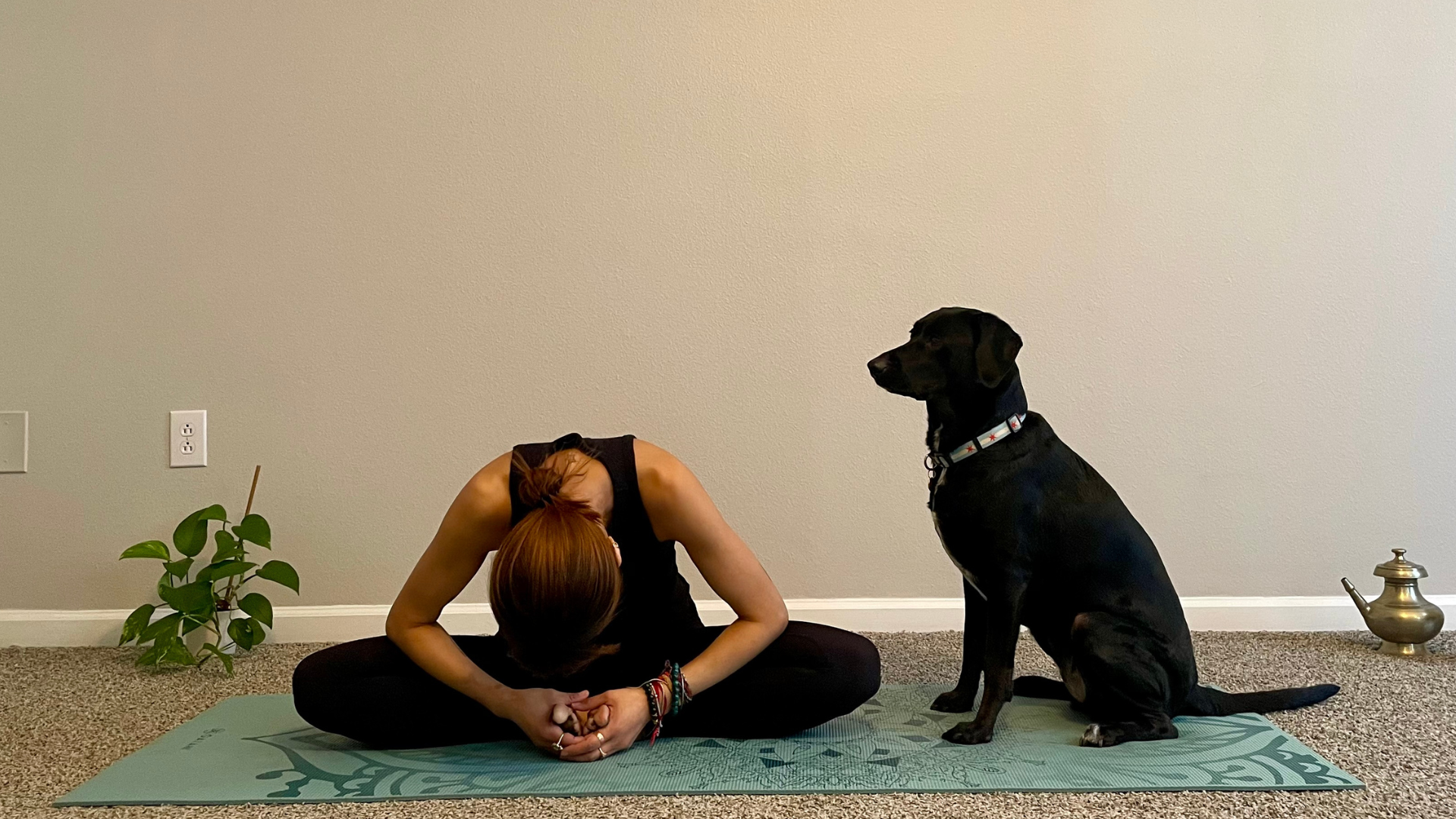 Woman sitting on a mat practicing yoga for anxiety 