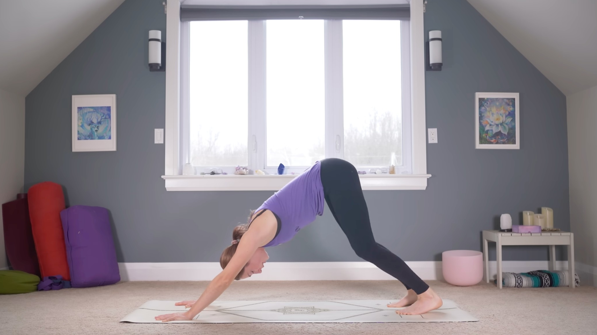 Woman on a yoga mat in Downward-Facing Dog