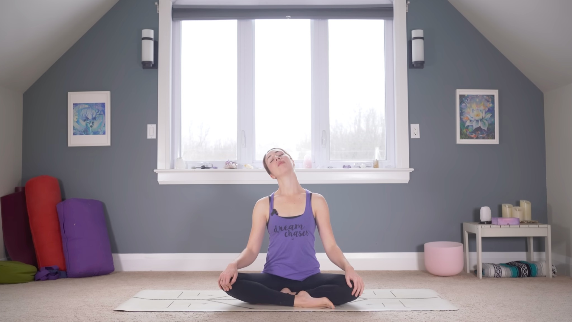 Beginner to yoga sitting cross-legged on a mat