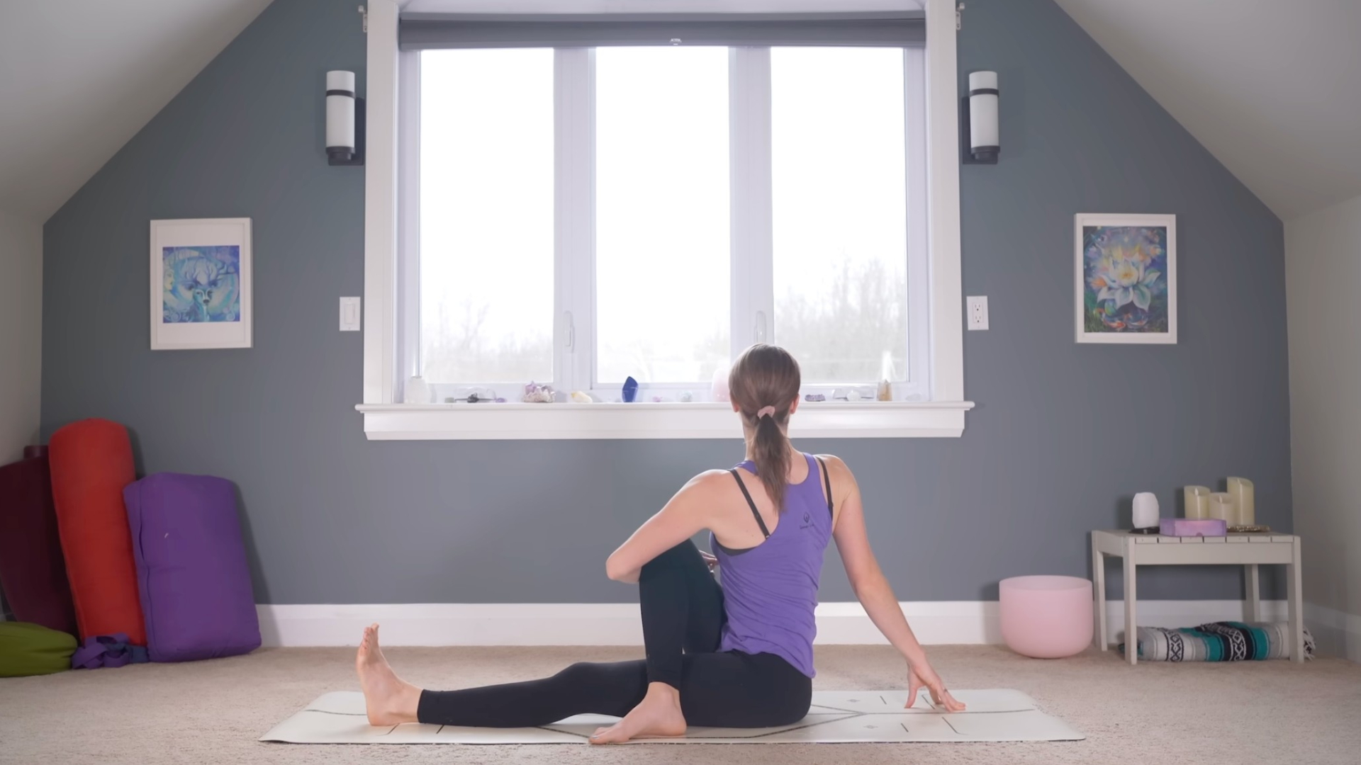 Woman practicing yoga for beginners while sitting on a mat in a twist