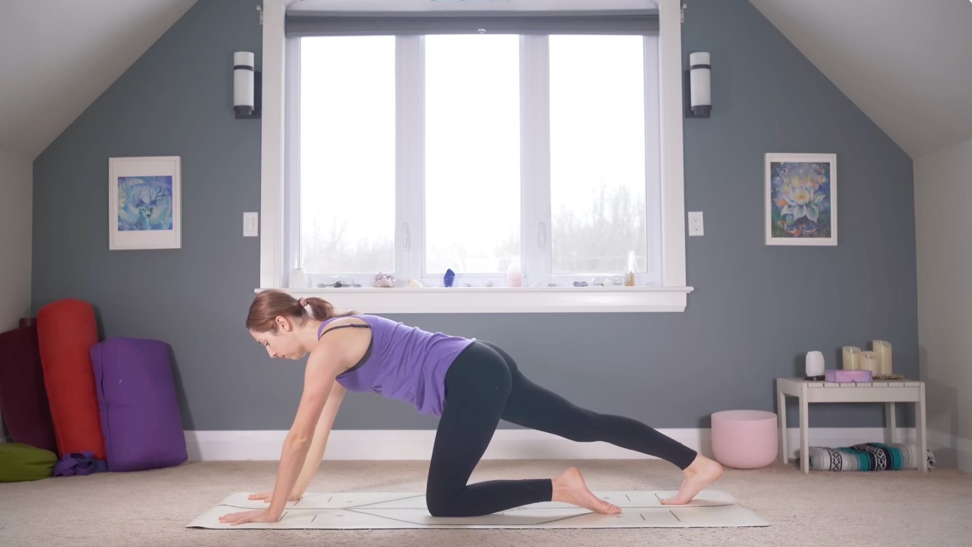 Woman kneeling on a mat with one foot behind her